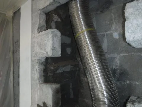 New flue being installed during chimney repair