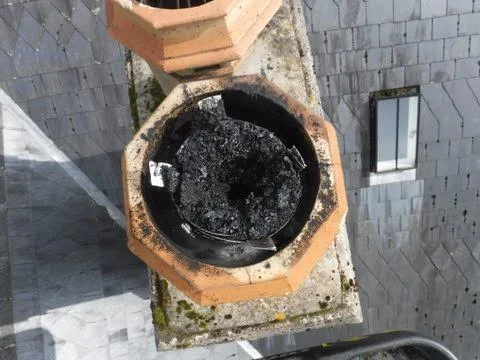 Excessive soot build up due to the flue not being cleaned right to the top