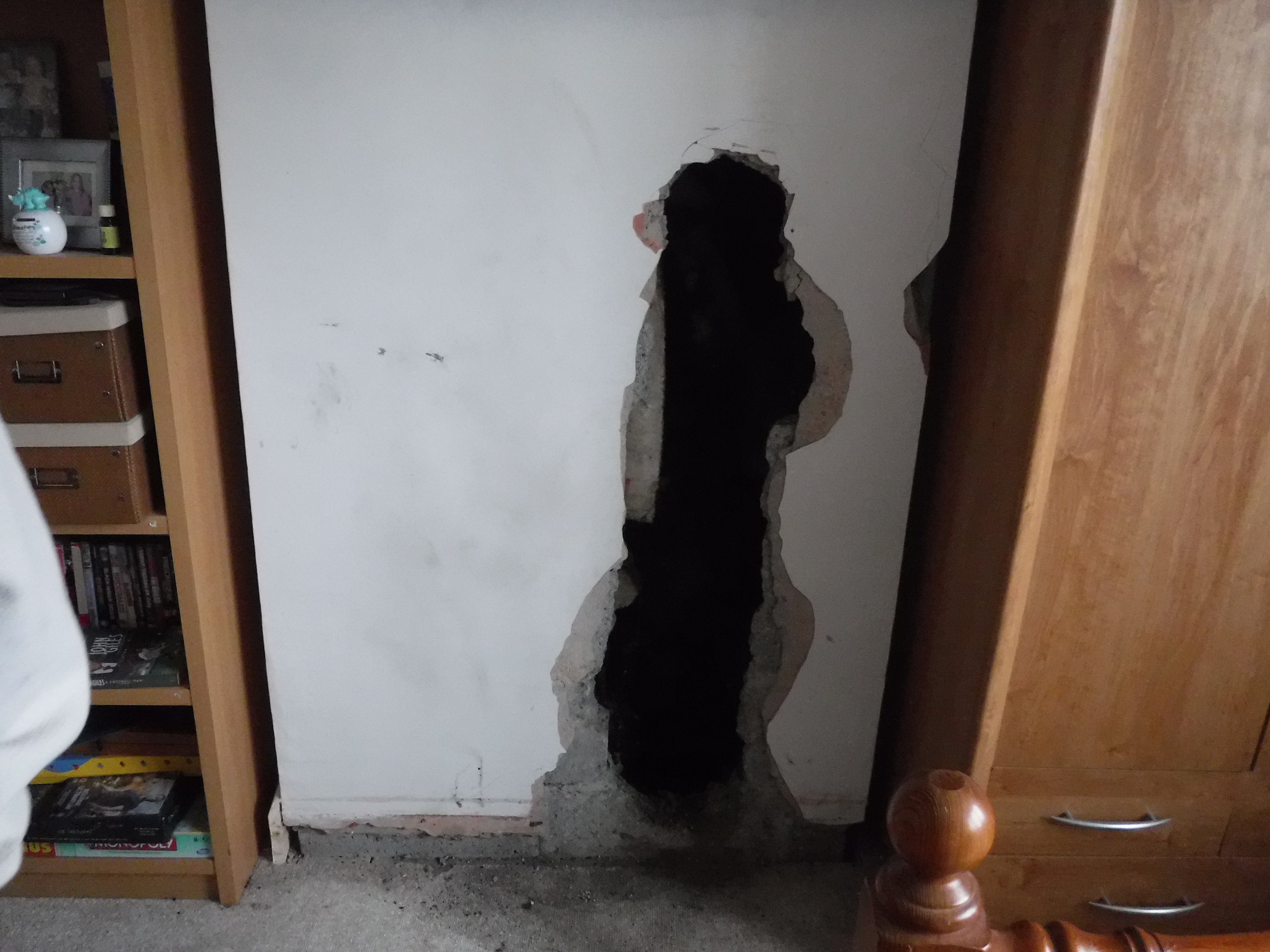 Opening made upstairs by fire brigade to get access to between the flues in order to extinguish the fire that was located in the space between the clay flue and the flexible liner.
