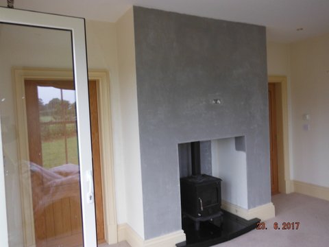 Completed chimney breast with stove installed.