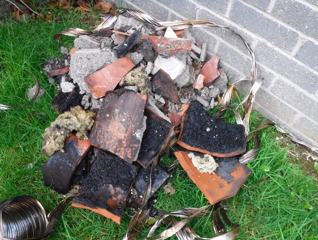 Flues as remove from the chimney stack. Note the buildup of soot on the inside of the flue and the scorched steel liner.