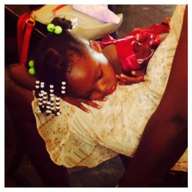 Worn out from the ceremony, a younger sibling takes a nap!