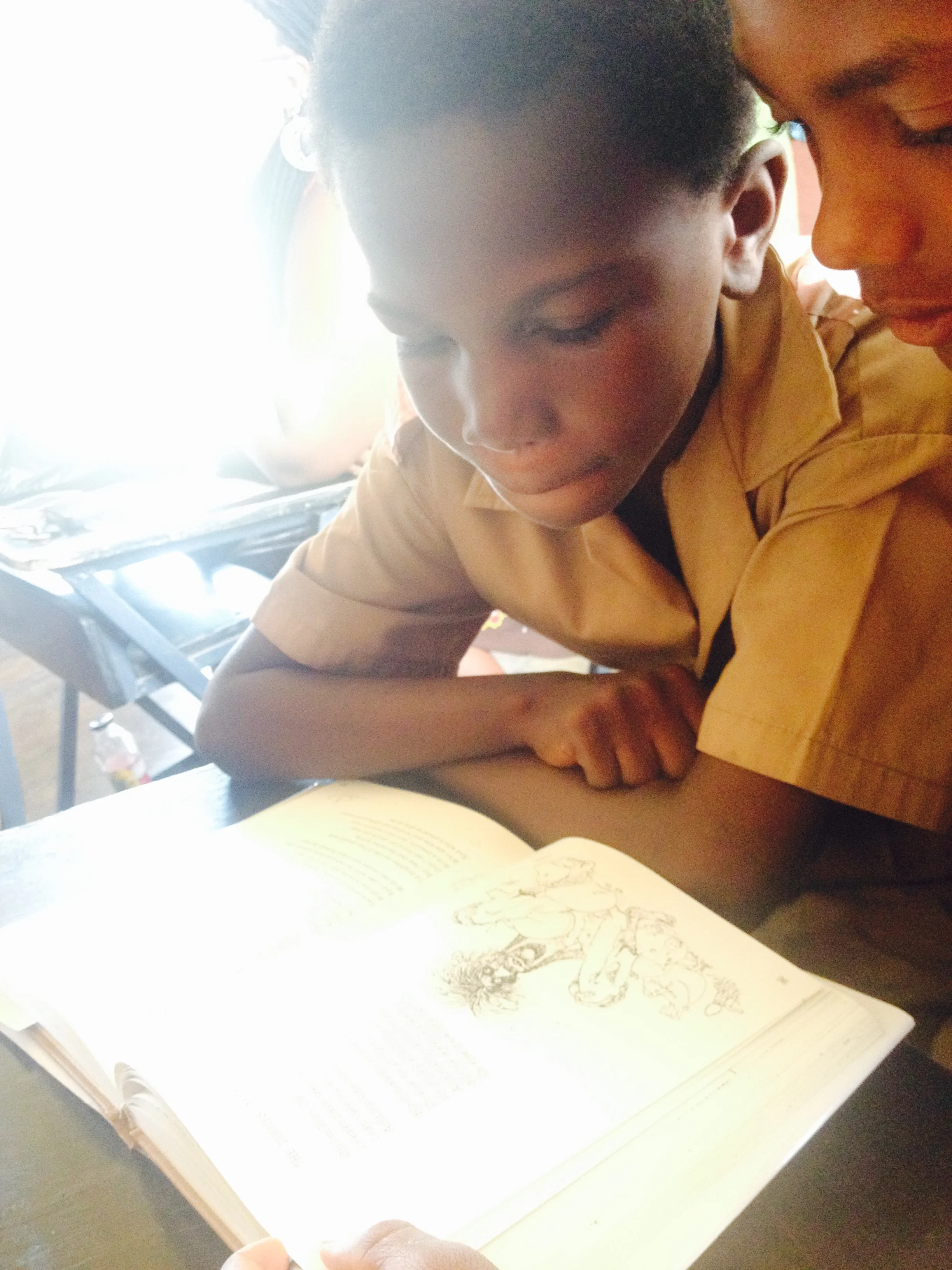 Reading "Where the Sidewalk Ends", one of Kim's gifts to the students.