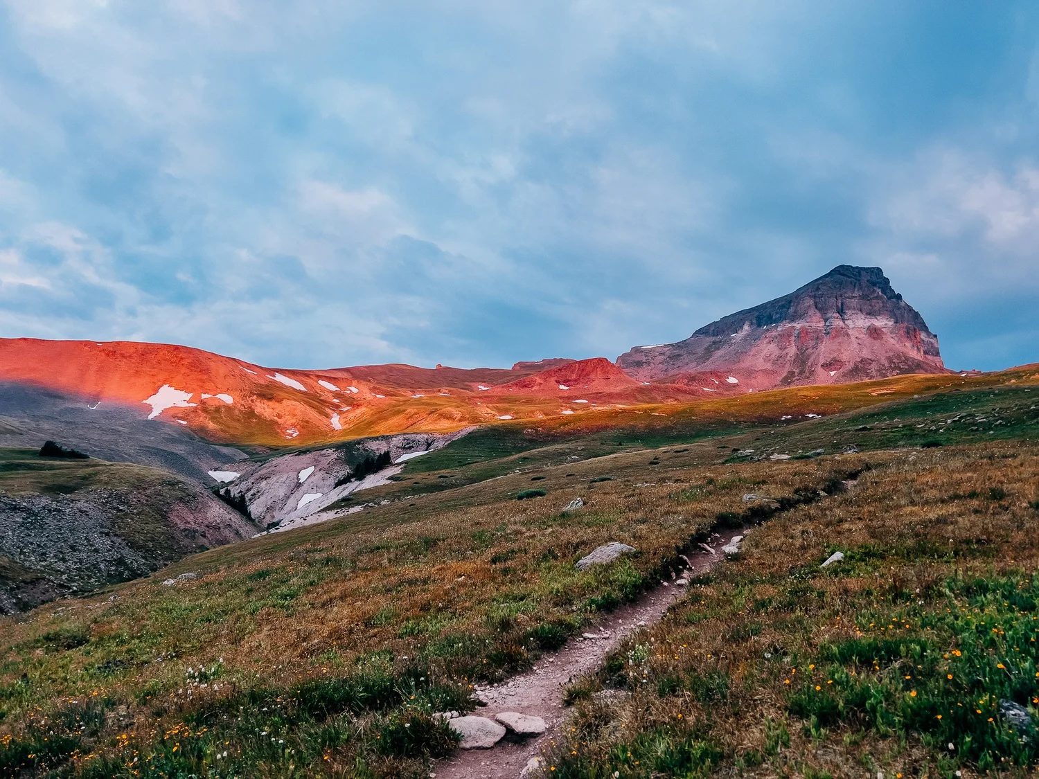 The mesa-like summit of Uncompahgre lit up through the clouds