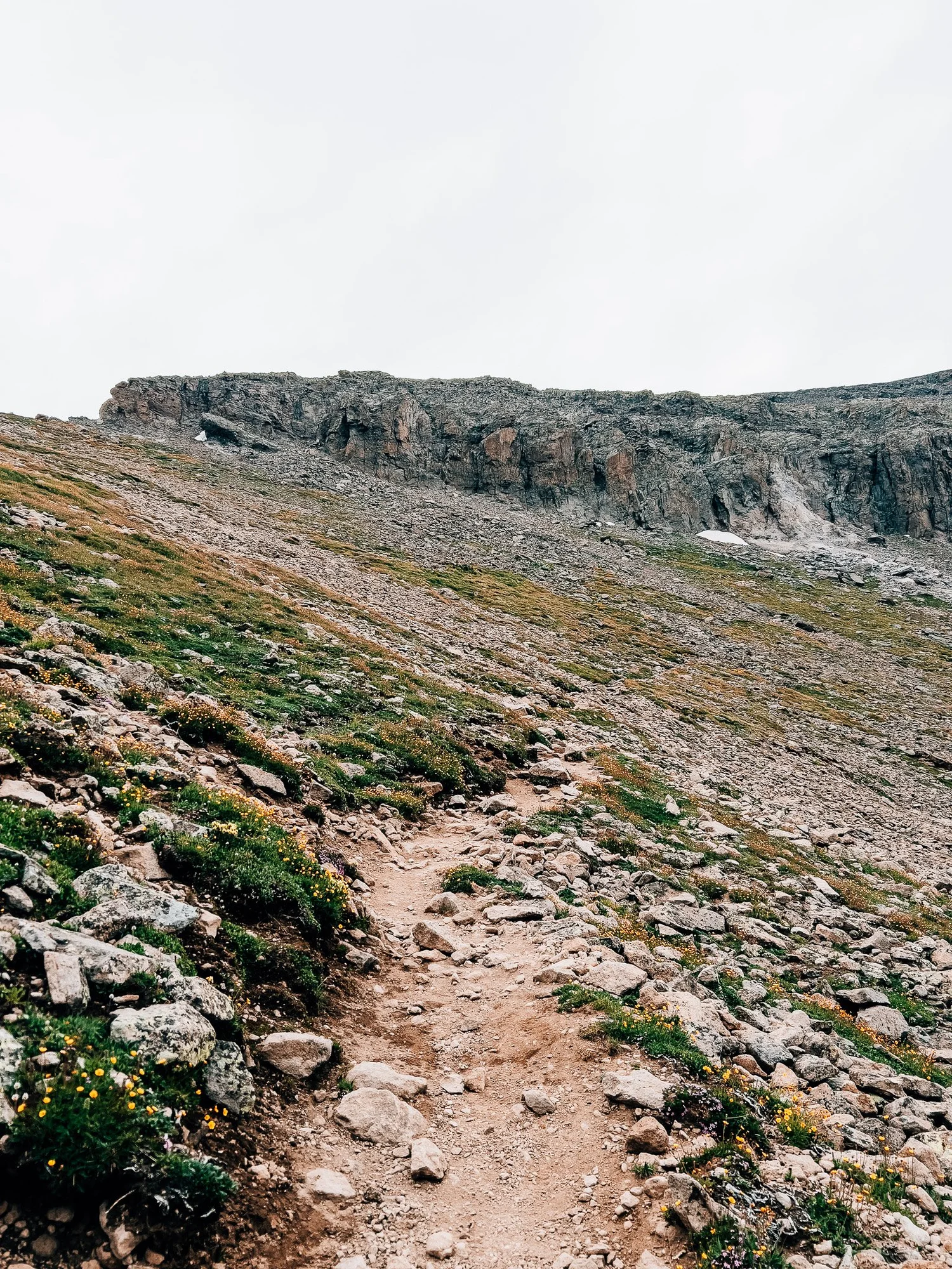 Rocky trail steepening toward the upper mountain