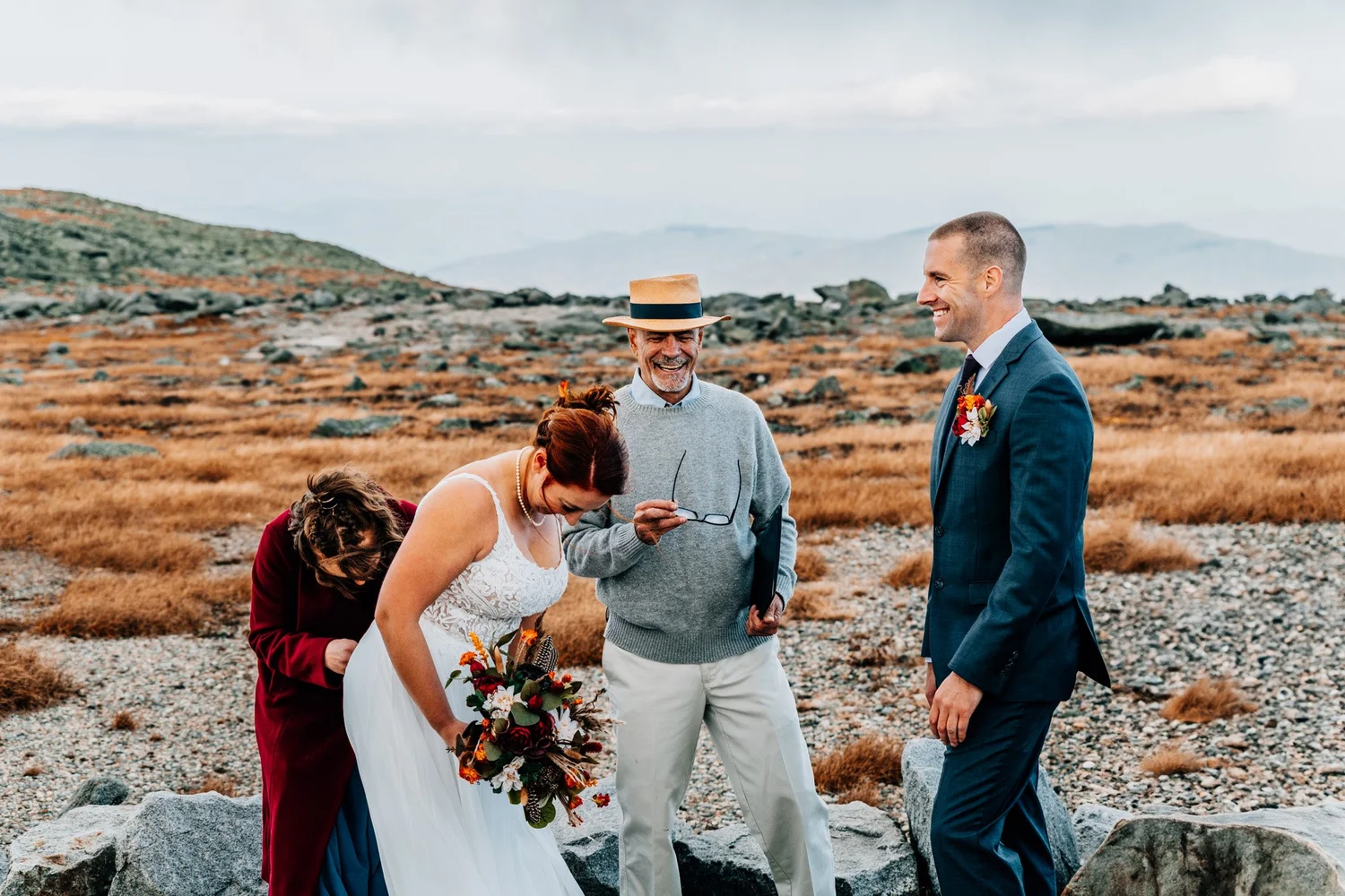 Bride laughing with officiant Mike Cherim before the ceremony at a pull-off on the Mount Washington Auto Road