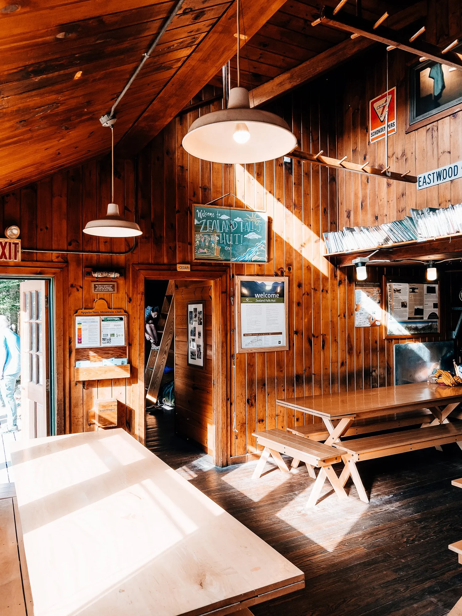 Warm wood interior of Zealand Falls Hut dining room