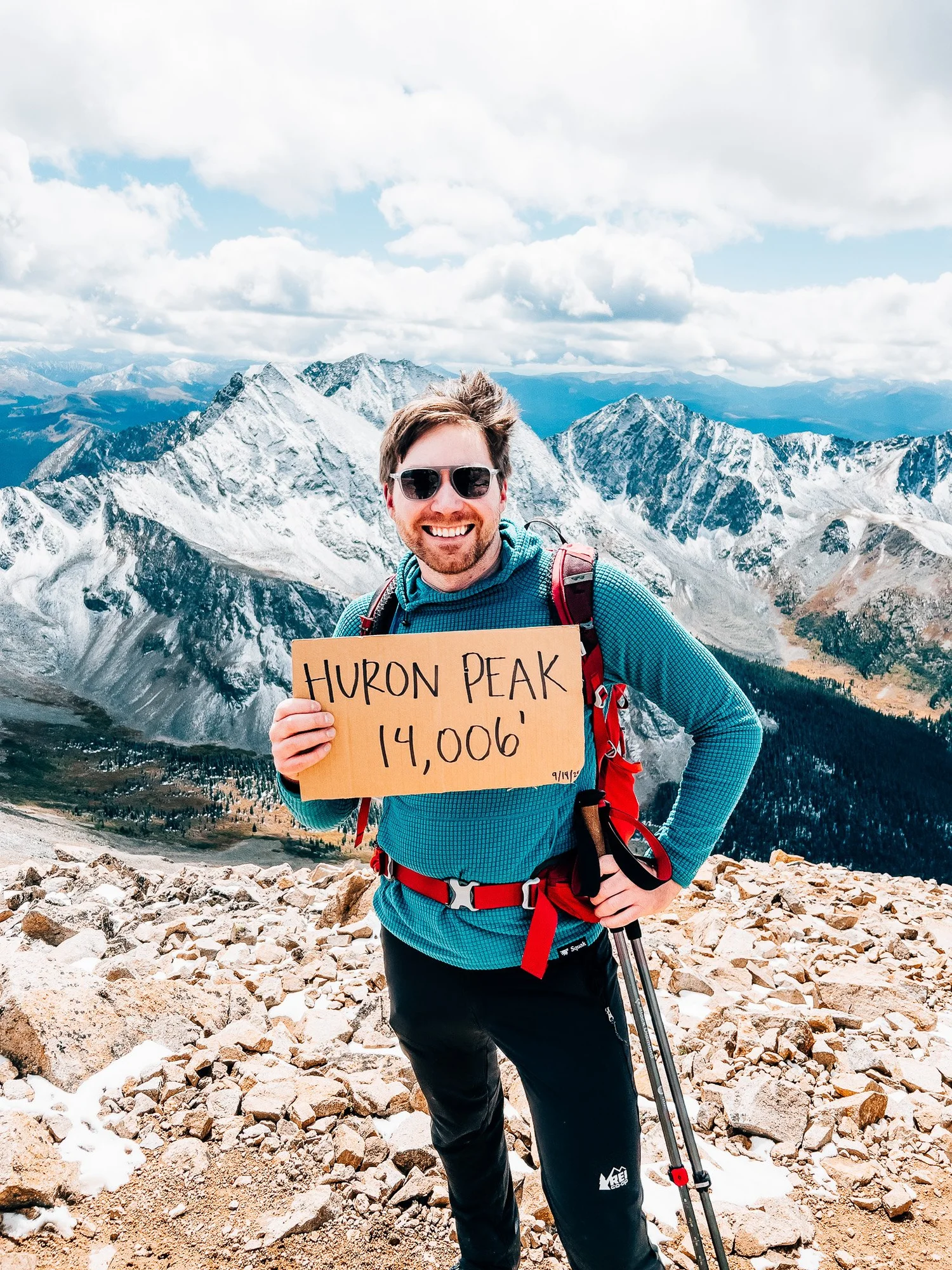 On the airy summit of Huron Peak with neighboring snow-capped 14ers