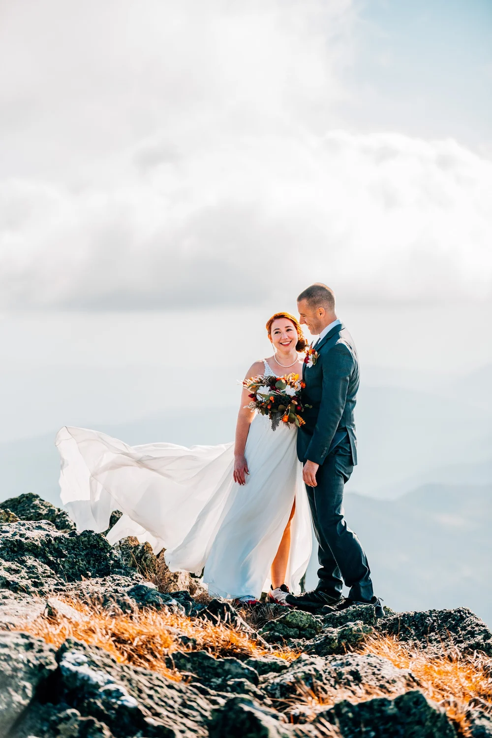 Elopement couple on a mountain summit in New Hampshire at golden hour