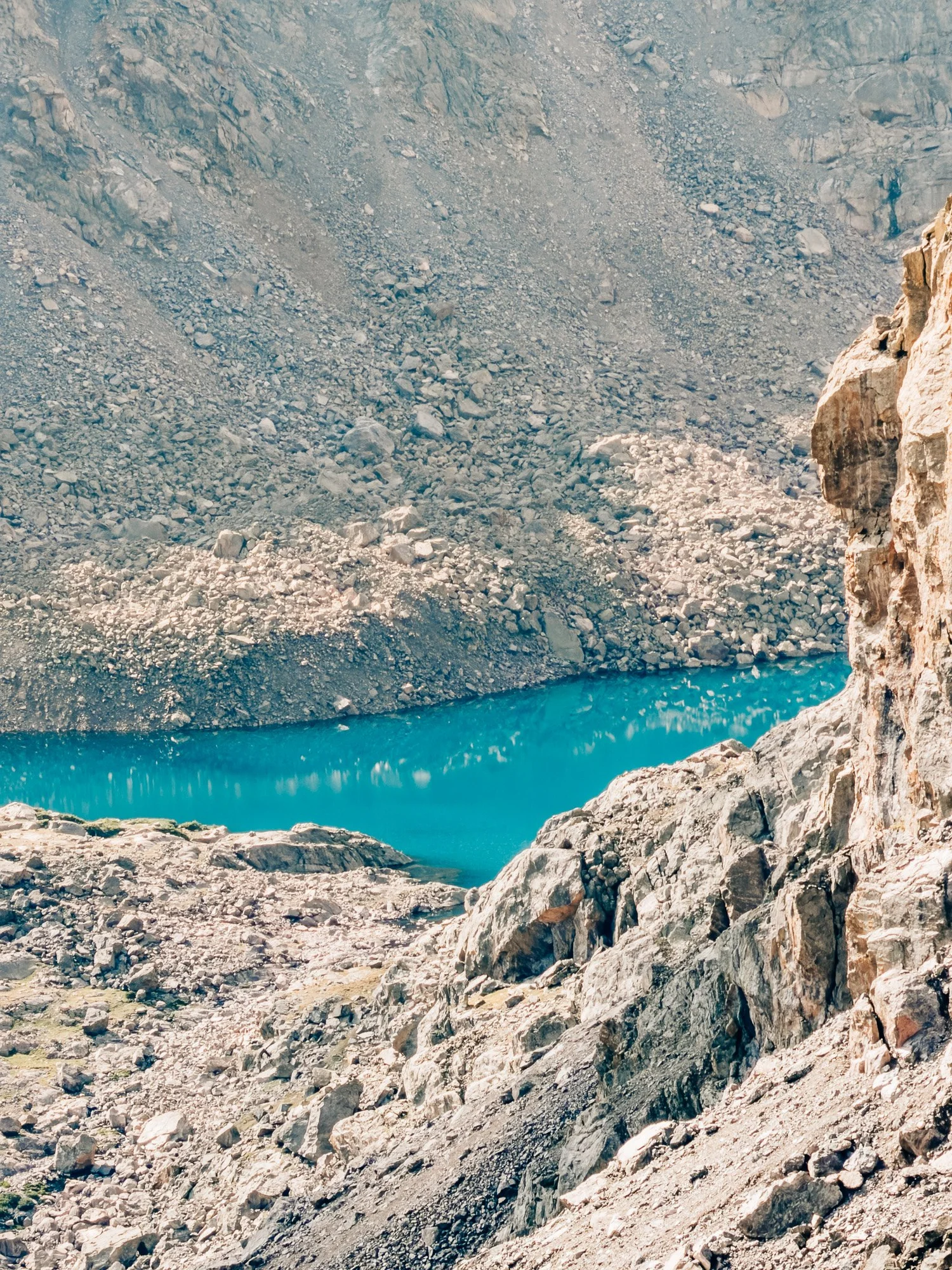 Turquoise alpine lake in the basin below the North Ridge
