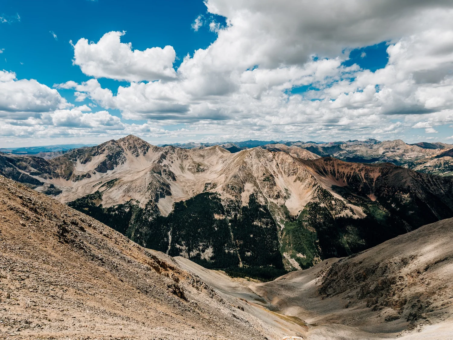 Huron Peak and the Collegiate Peaks under building summer clouds, seen across the valley from Missouri Mountain&rsquo;s northwest ridge