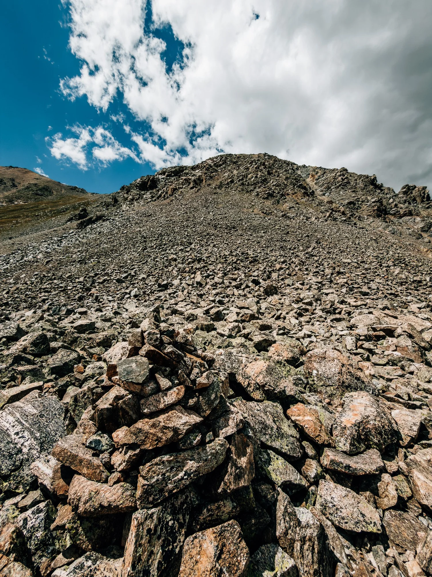 Cairn on a steep slope of loose rock and scree leading up to the saddle on Missouri Mountain