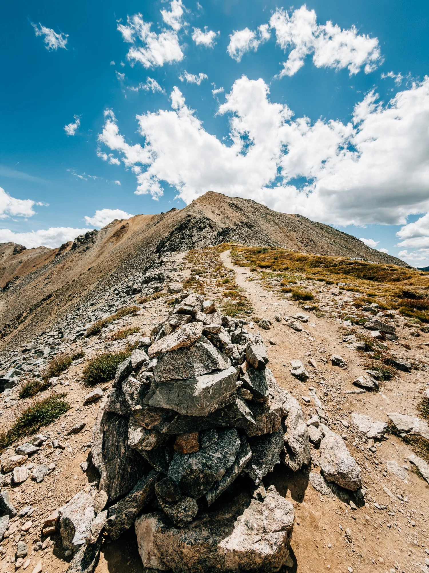 Large cairn on the 13,700-foot saddle with the trail continuing up Missouri Mountain&rsquo;s northwest ridge