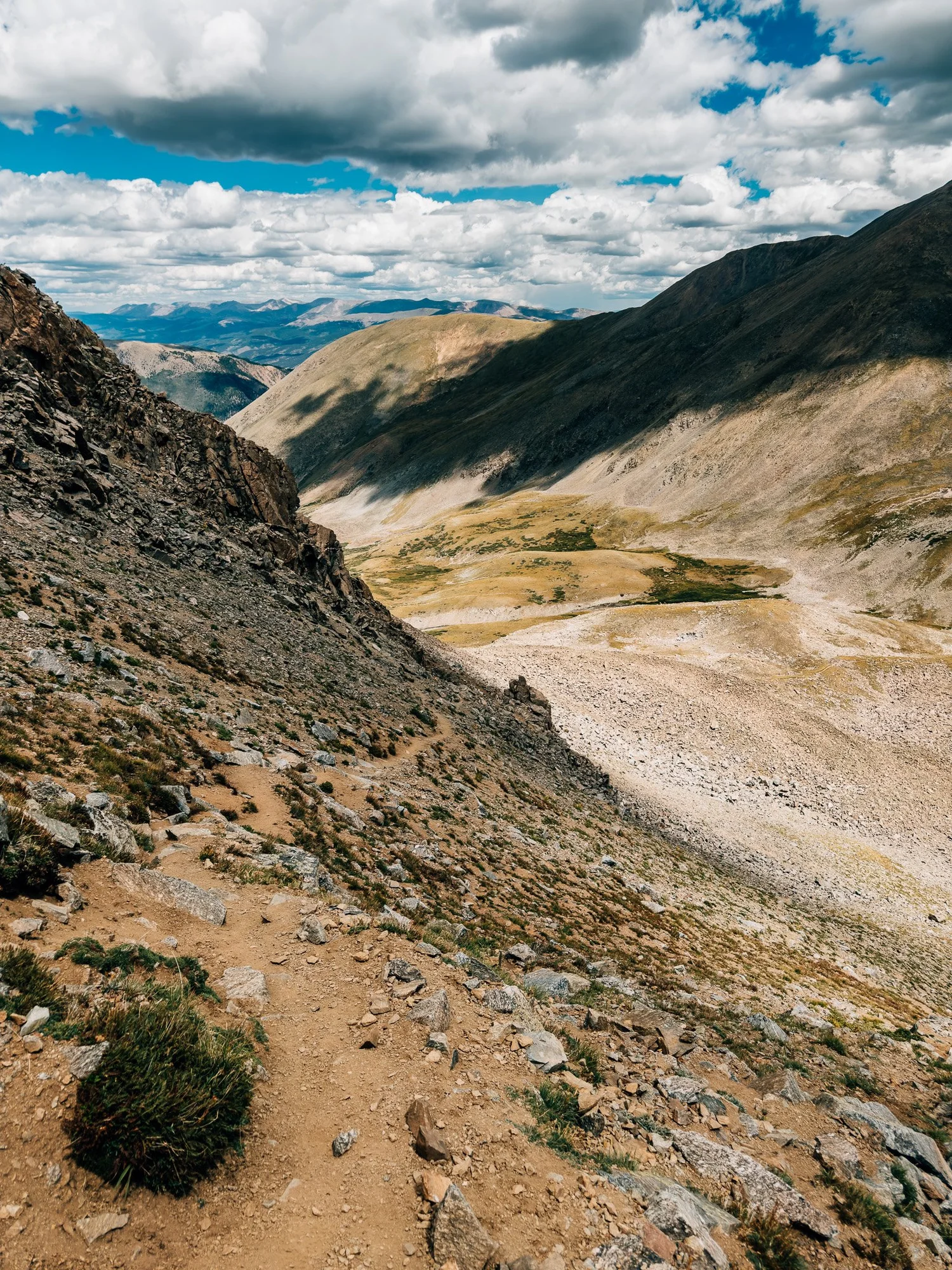 Looking down a steep, rocky trail toward the upper Missouri Gulch basin far below
