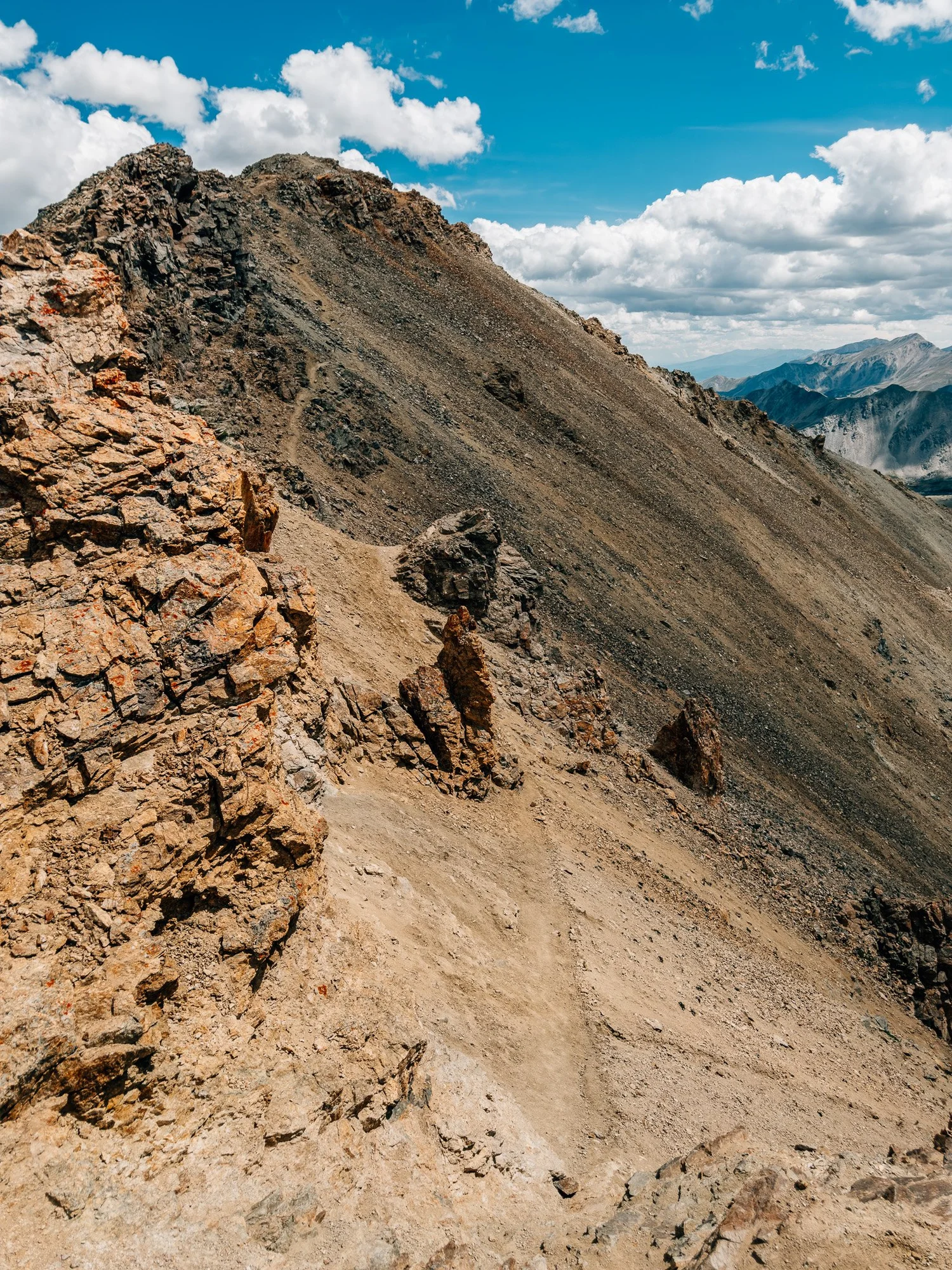 Sandy trail traversing below rock towers on the side of Missouri Mountain&rsquo;s northwest ridge near the summit