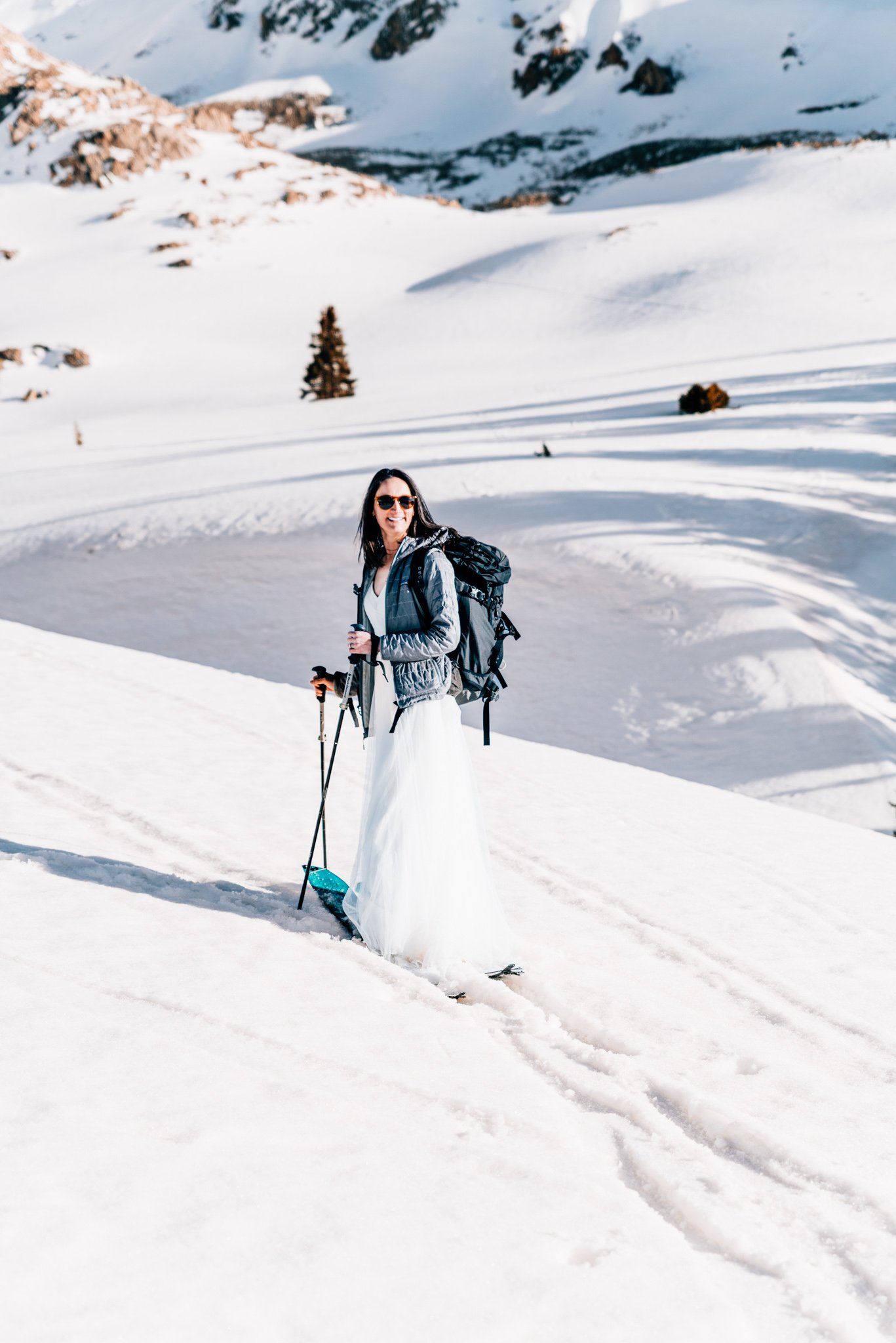 Bride on skis in a snow-filled Colorado basin