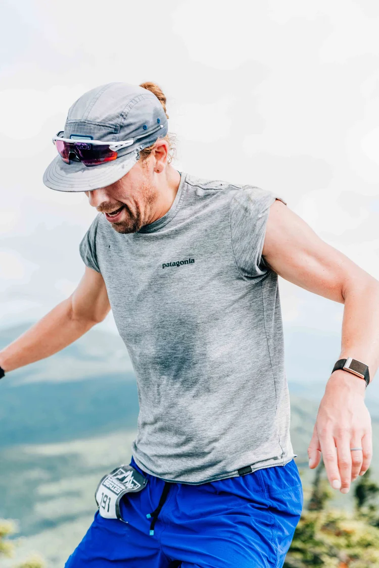 Trail runner in race bib 191 pushing along an exposed mountain ridge