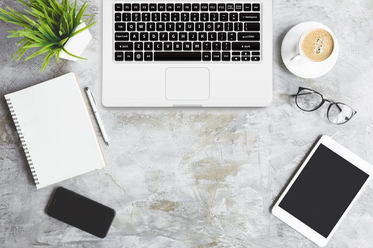 accounting table with laptop coffee notes and glasses.JPG