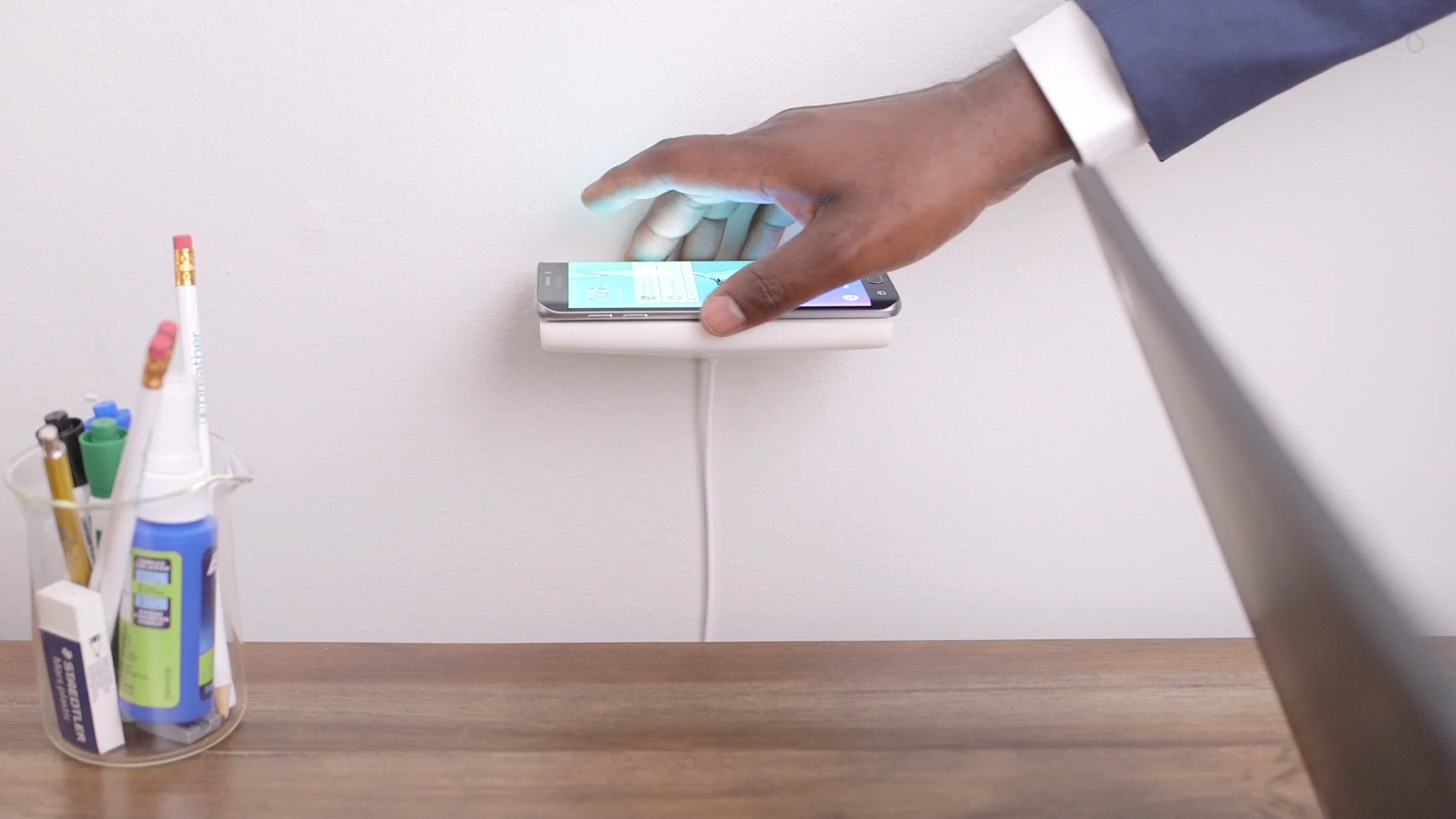 WallJax_float_s6edgePlus_mans_hand_placing.jpg