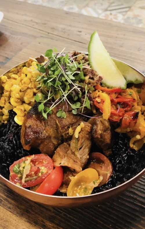 El TOro - braised pork shoulder, black rice, heirloom tomato salad, warm olive tapenade, charred corn succotash, chili oil, and micro cilantro.