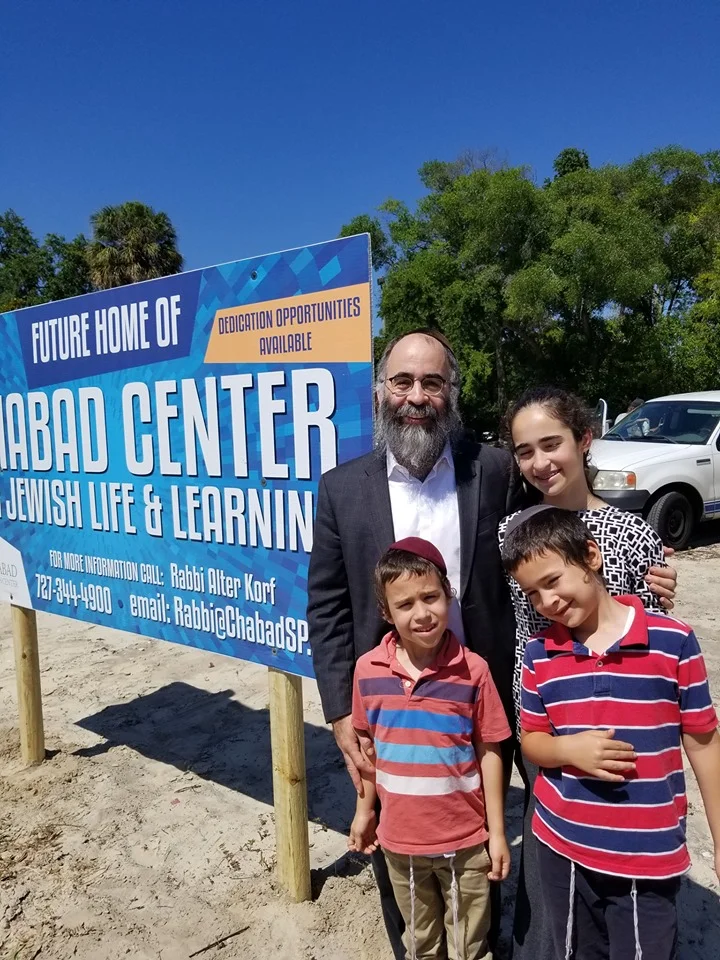 Rabbi Alter Korf and his kids standing at the future site of the Chabad Center for Jewish Life and Learning in Downtown St. Pete