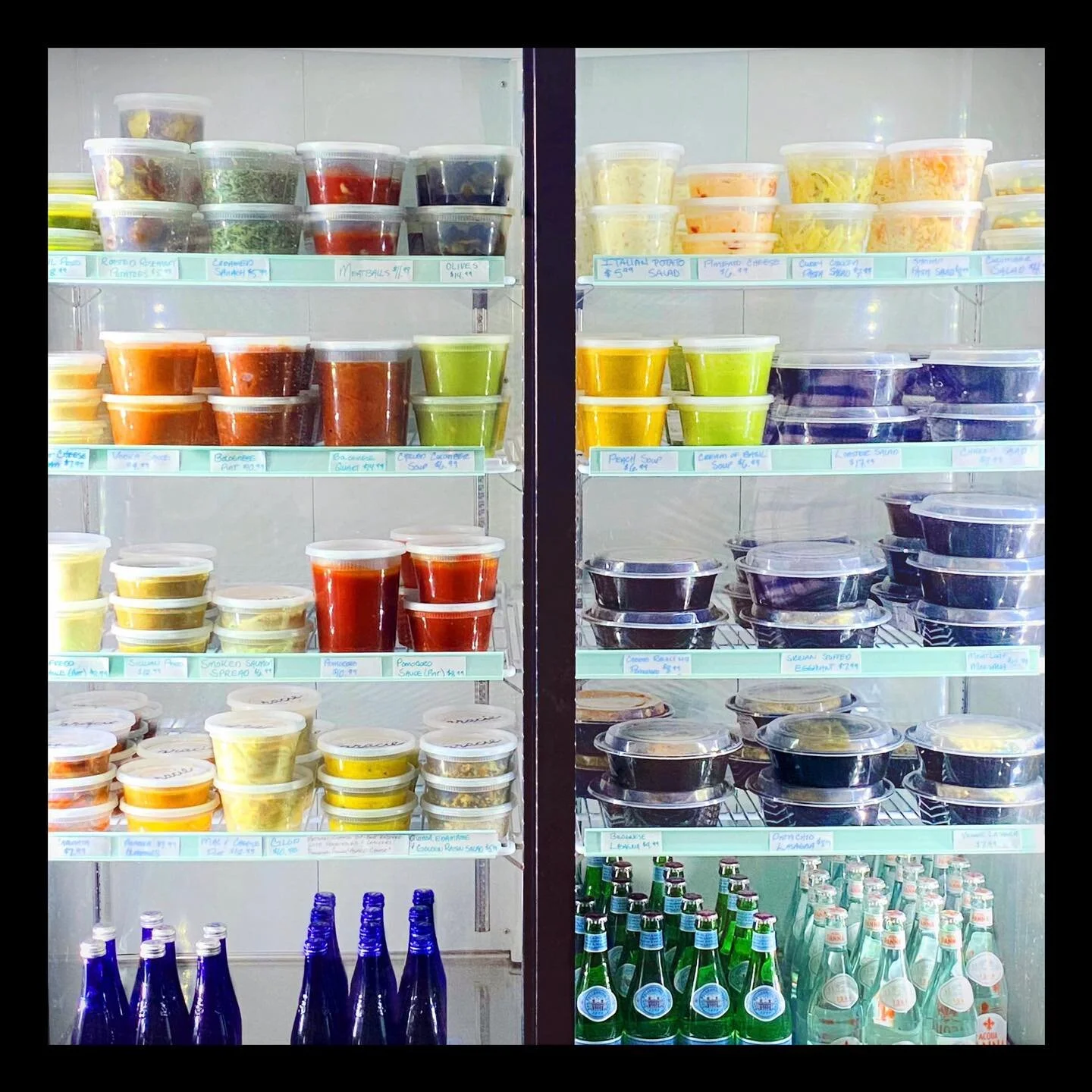 A frdige full of homemade sauces and prepared dishes at Gracie pasta and provisions
