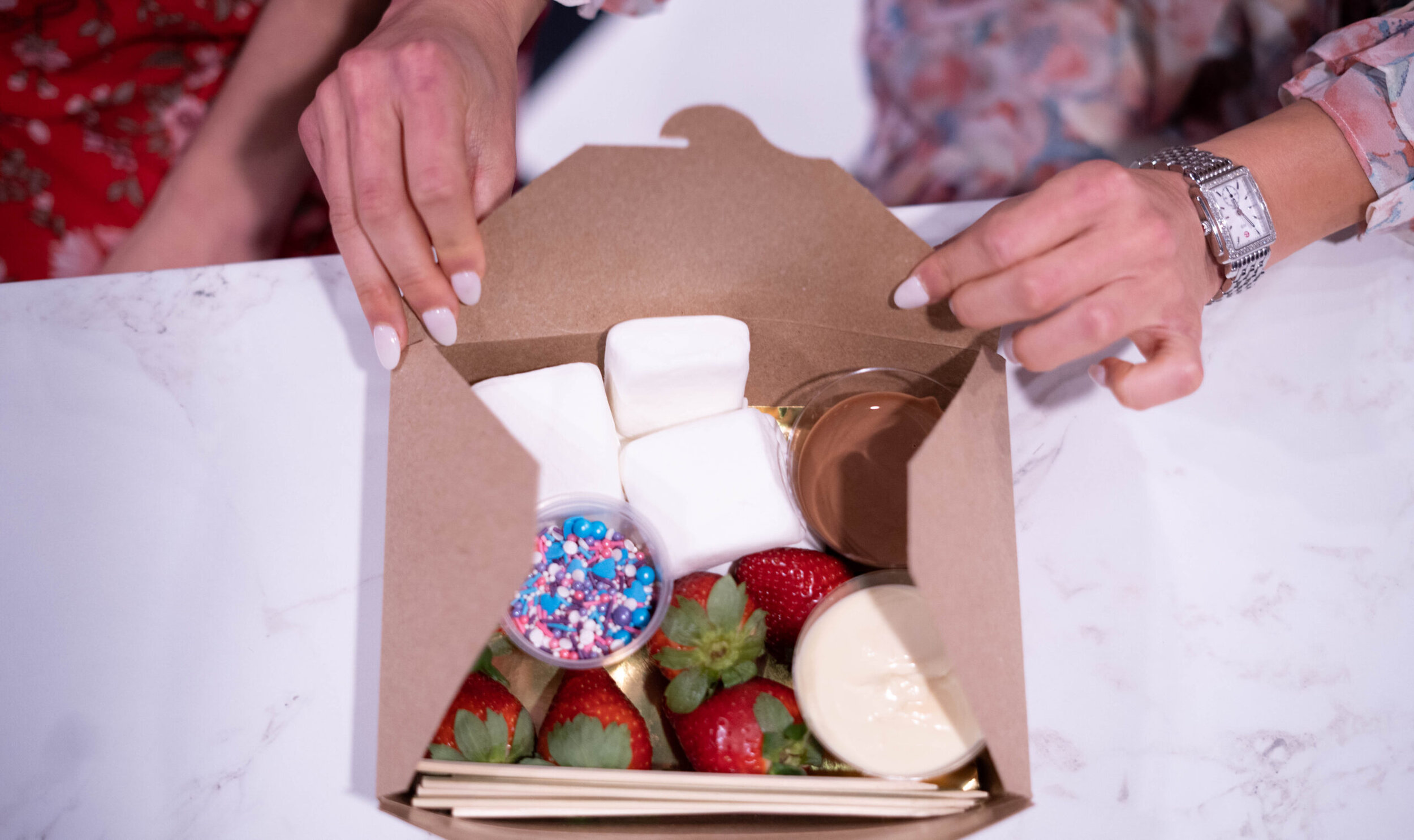 The Chocolate Tasting Flight comes with a tasty treat box that includes marshmallows, strawberries, milk chocolate, and sprinkles