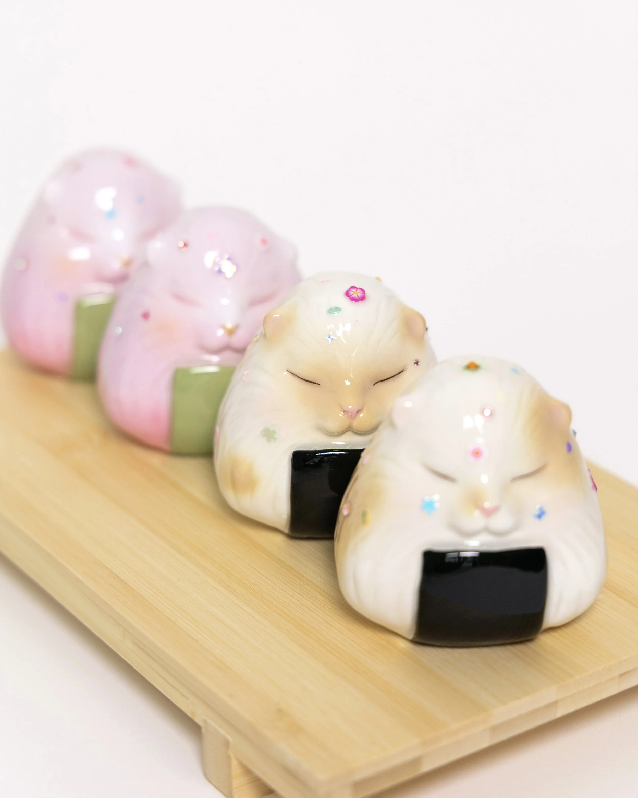 CAT ONIGIRI. Epoxy clay, acrylic paint, resin. Approx. 2 × 3 × 3 in (L × W × H)