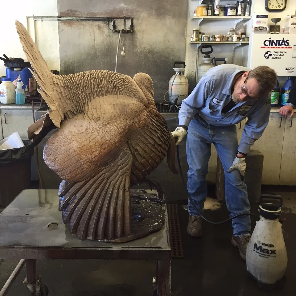 Art Castings of Colorado's master patina artist Nate Ford applying Liver of Sulfur to the bronze.