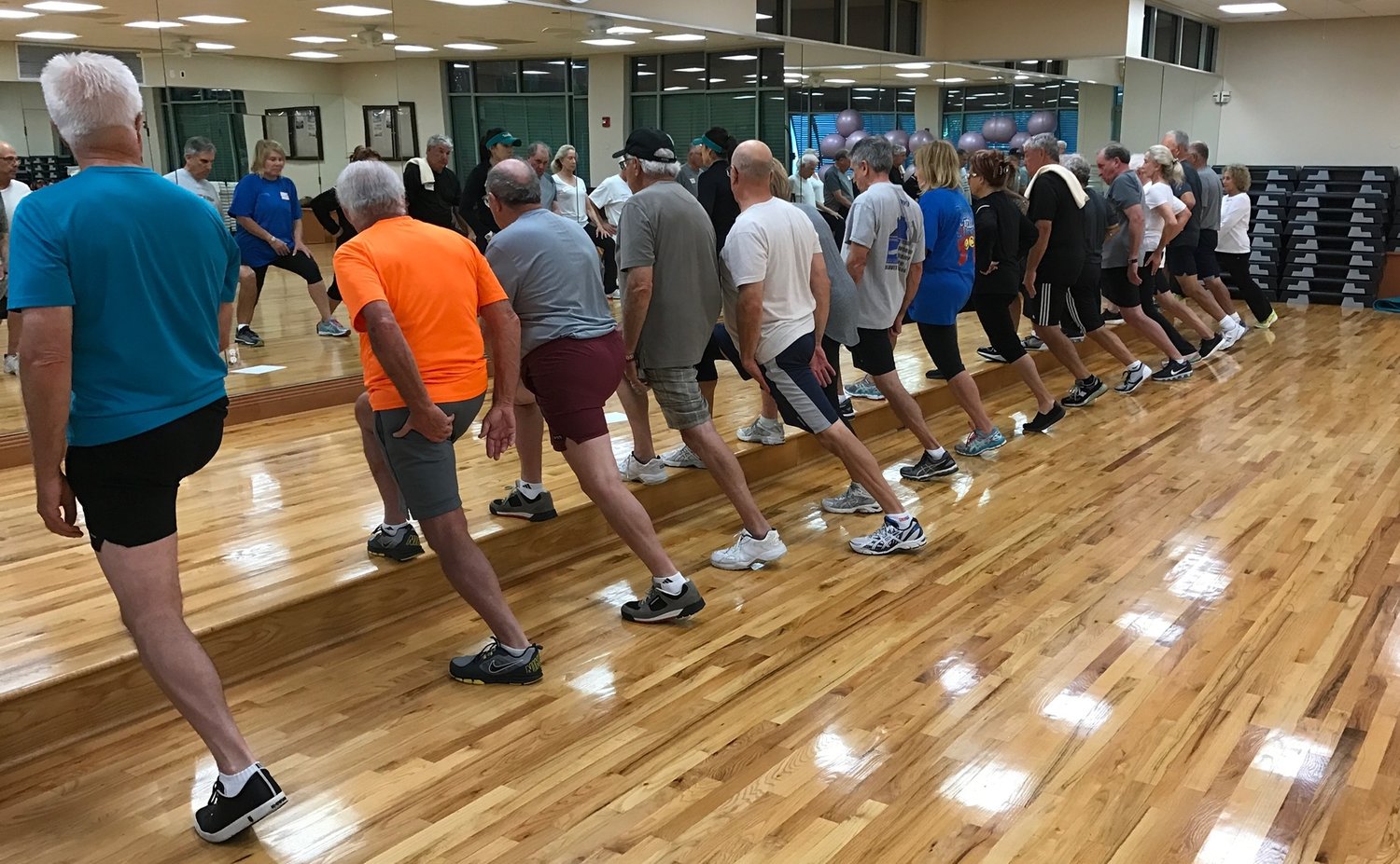 MEMBERS AT A LOCAL COUNTRY CLUB PARTICIPATING IN THE WEEKLY GOLF FITNESS CLASS 