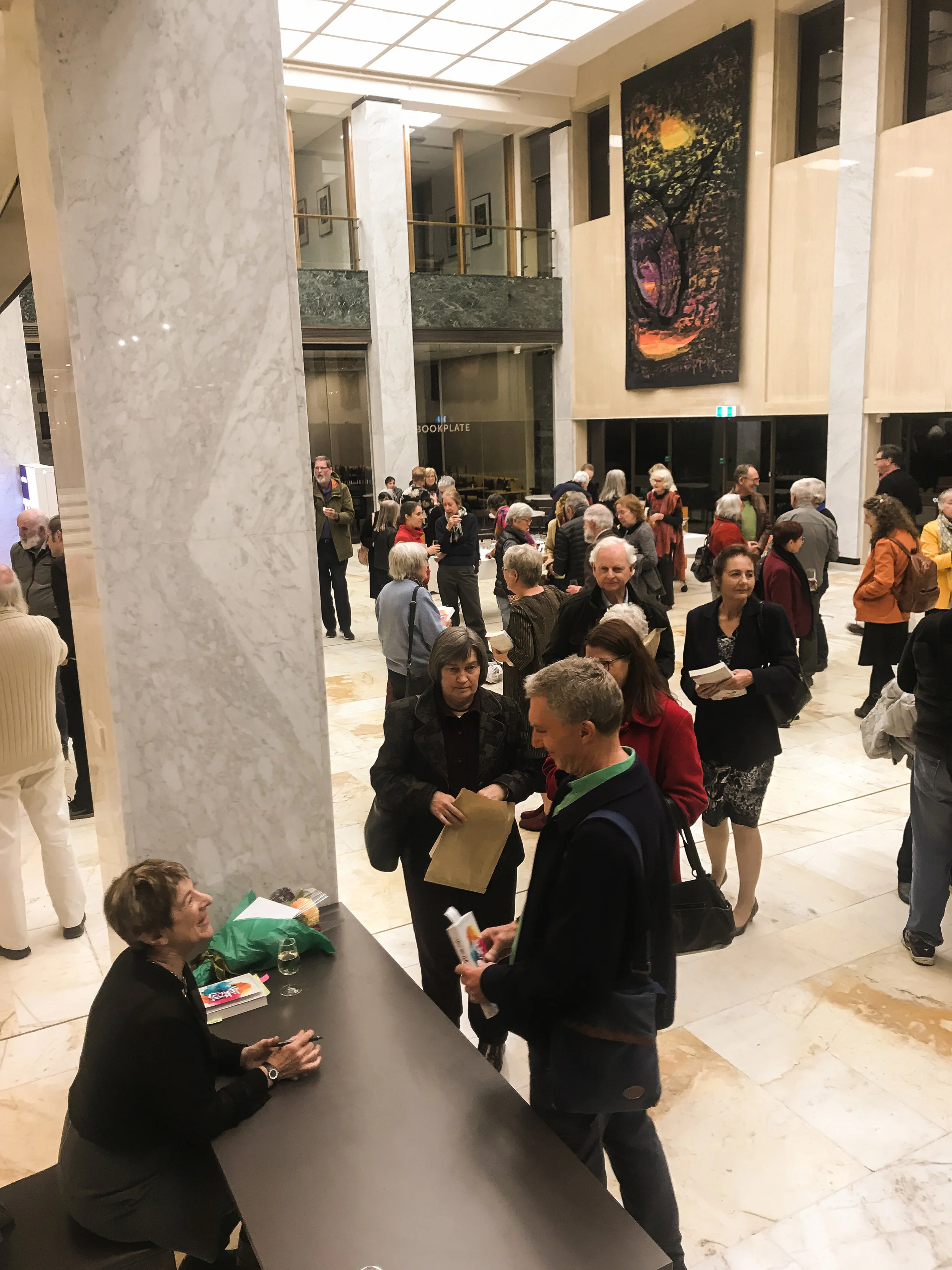 A room abuzz with energy as people wait for their signed copy of After She Left