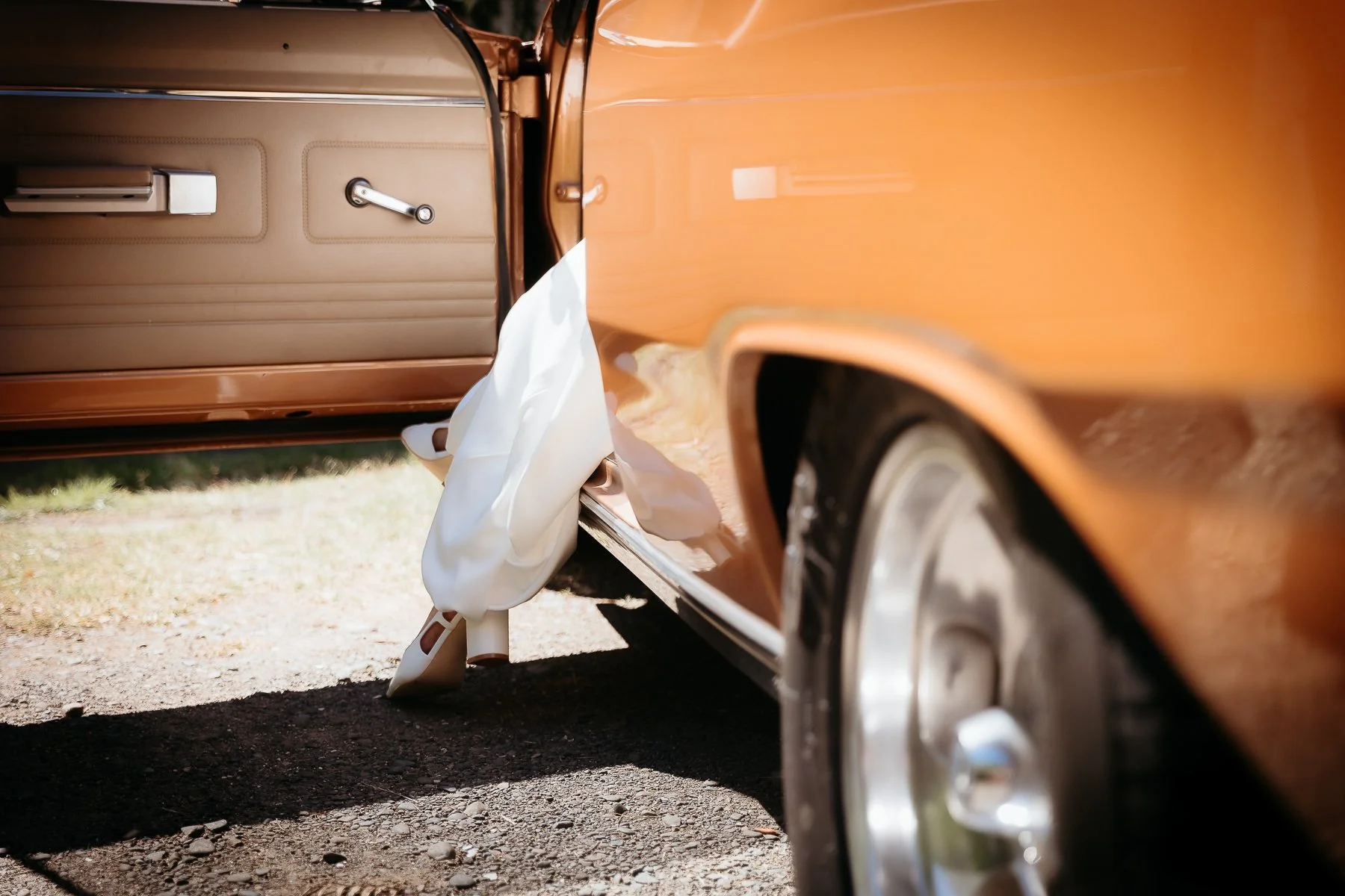 bride-steps-out-of-car-hawkes-bay-wedding-photographers