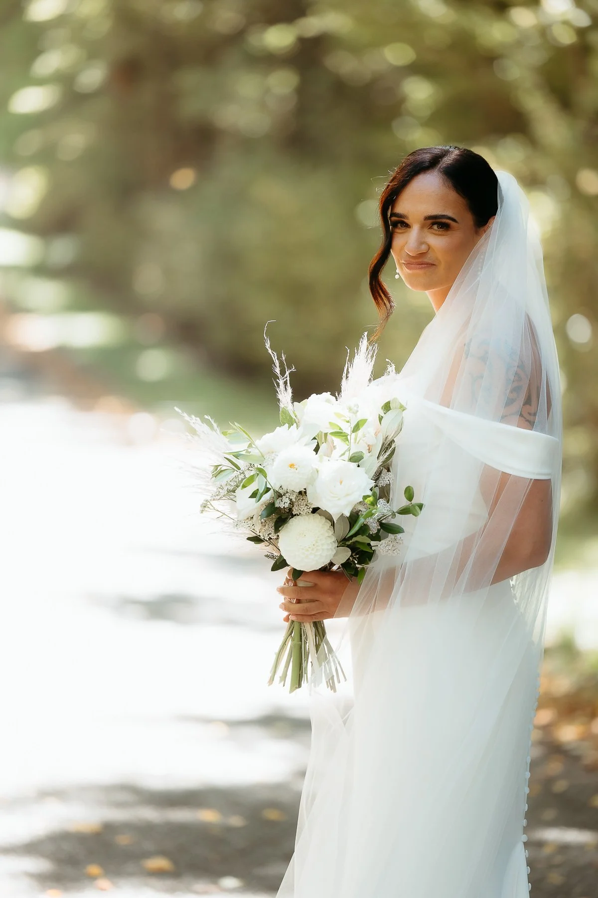 bride-at-hawkes-bay-wedding-holding-flowers-in-professional-wedding-photography-by-Eva-Bradley