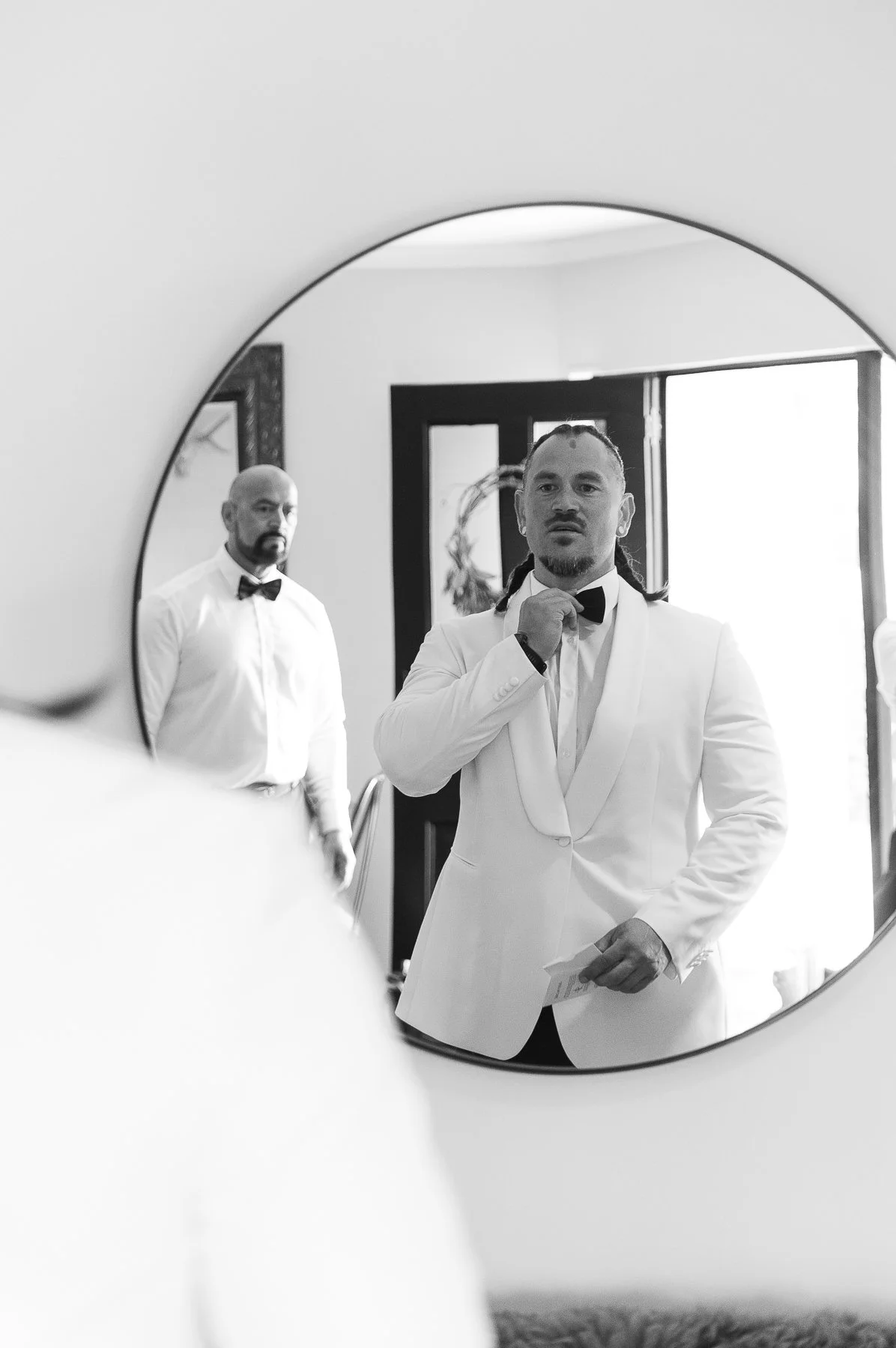 groom-adjusts-bowtie-in-mirror-hawkes-bay-wedding-venues
