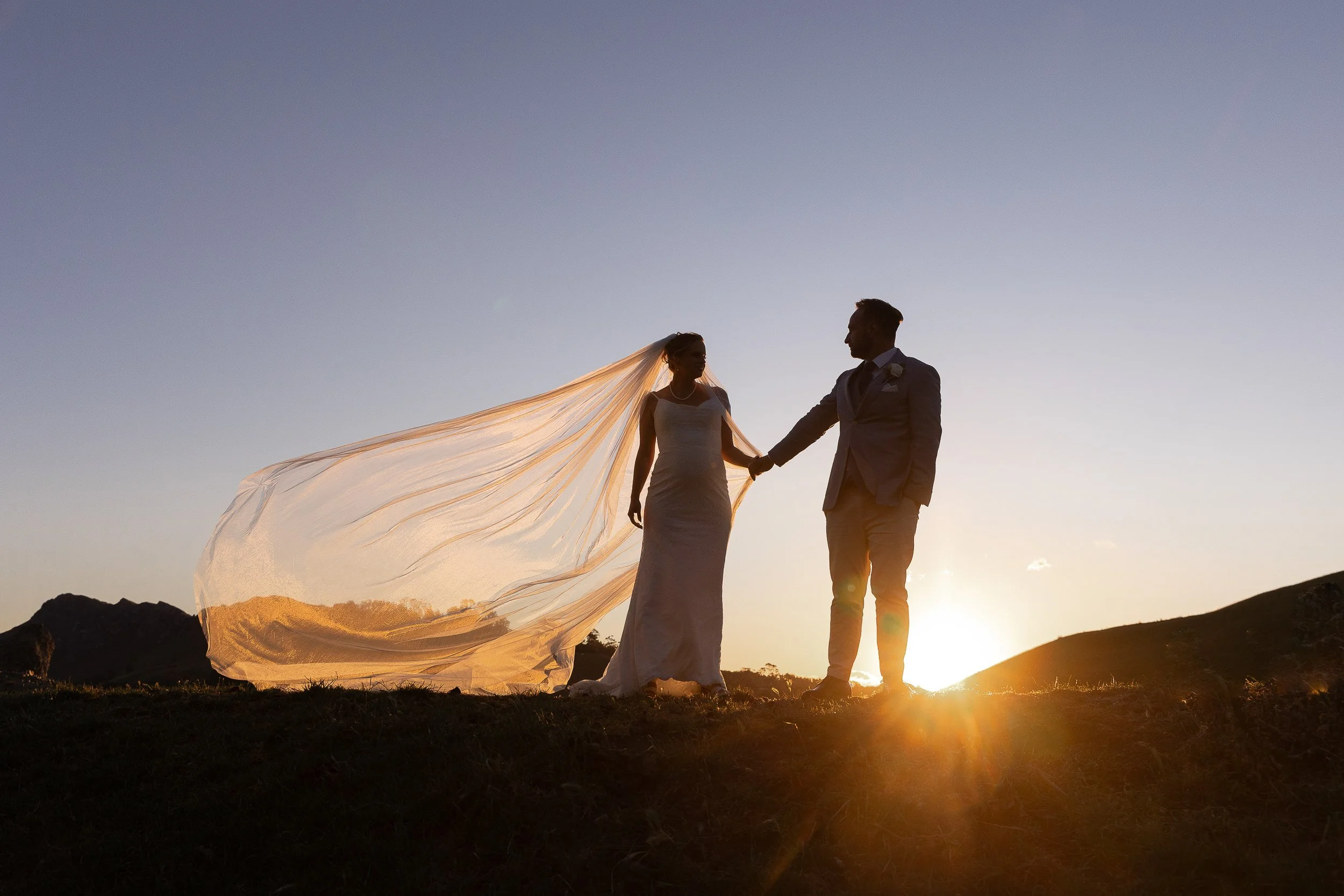 bride-and-groom-at-sunset-with-veil-hawkes-bay-photographer
