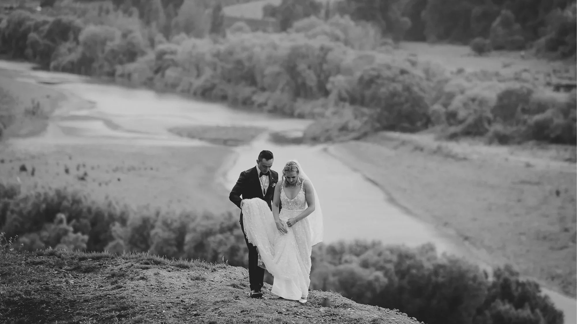 A bride and groom walk along a ridgetop in a photo by best Hawkes Bay wedding photographer, Eva Bradley Photography