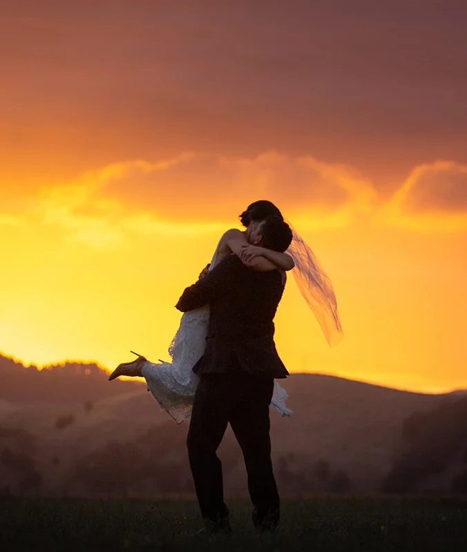 A couple on their wedding day in Hawke's Bay hug at sunset. This is shot by one of the best nz wedding photographers, Eva Bradley, who has a studio in Napier, Hawke's Bay, new zealand