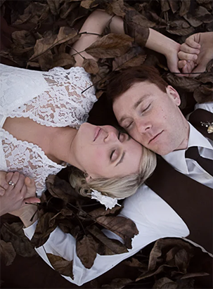 A couple lie on the ground posing for top Hawke's Bay wedding photographer, Eva Bradley, who is one of the best wedding photographers in nz and based in Napier, shooting at all the top Hawke's Bay wedding venues