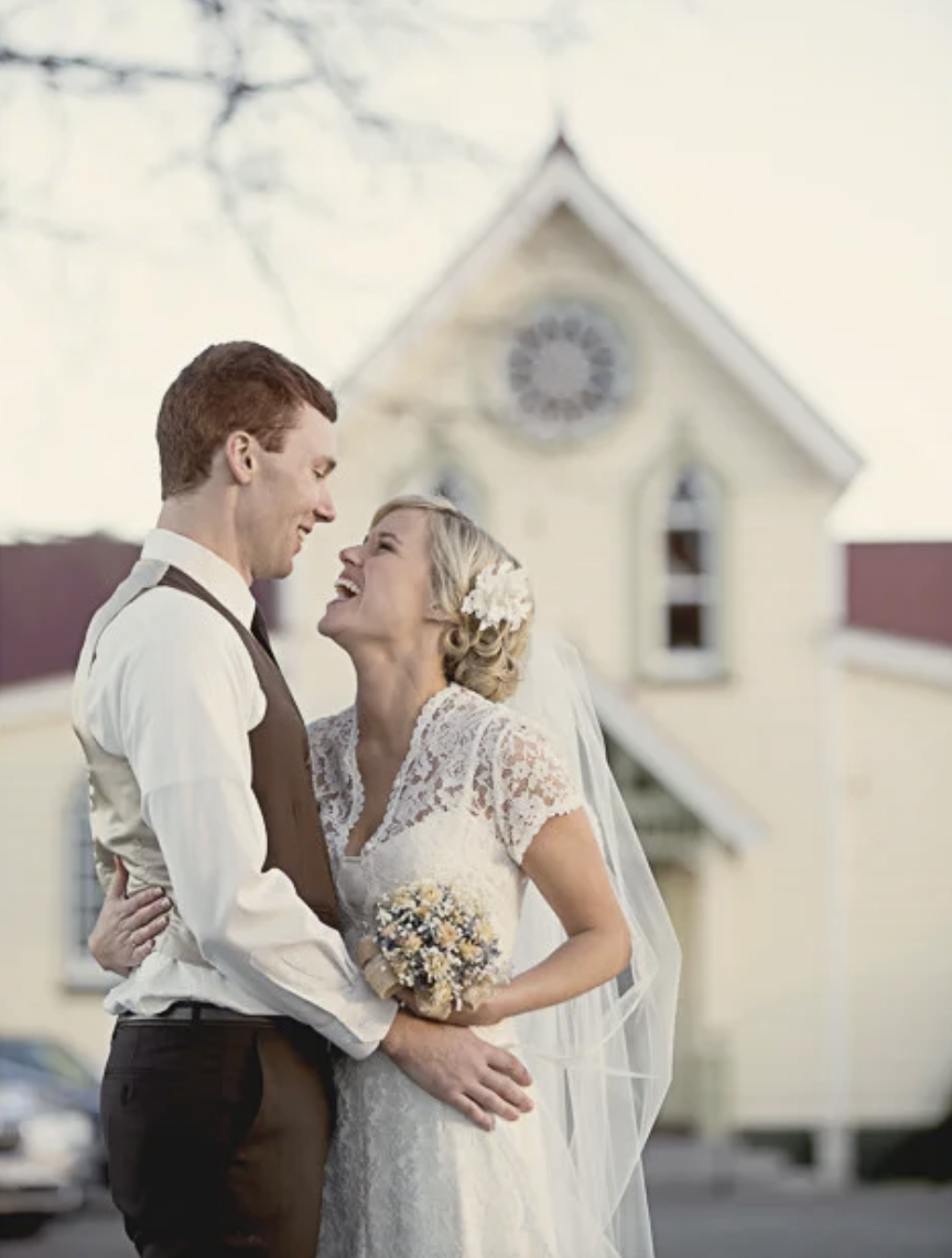 This is a bride and groom laughing at Hawke's Bay wedding venue, The Old Church, shot by best Hawke's Bay wedding photographer, Eva Bradley