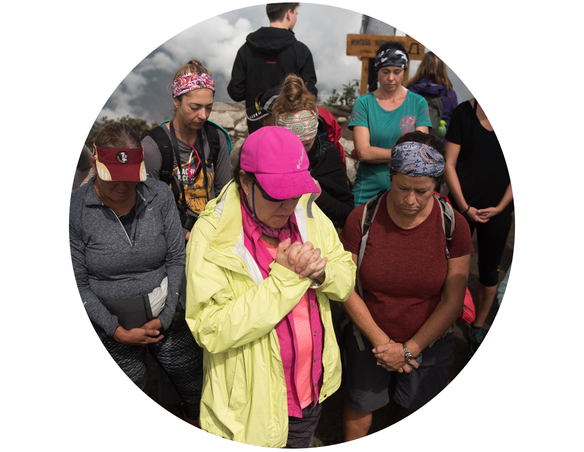 group of older women in outdoor gear praying for human trafficking with Freedom Challenge