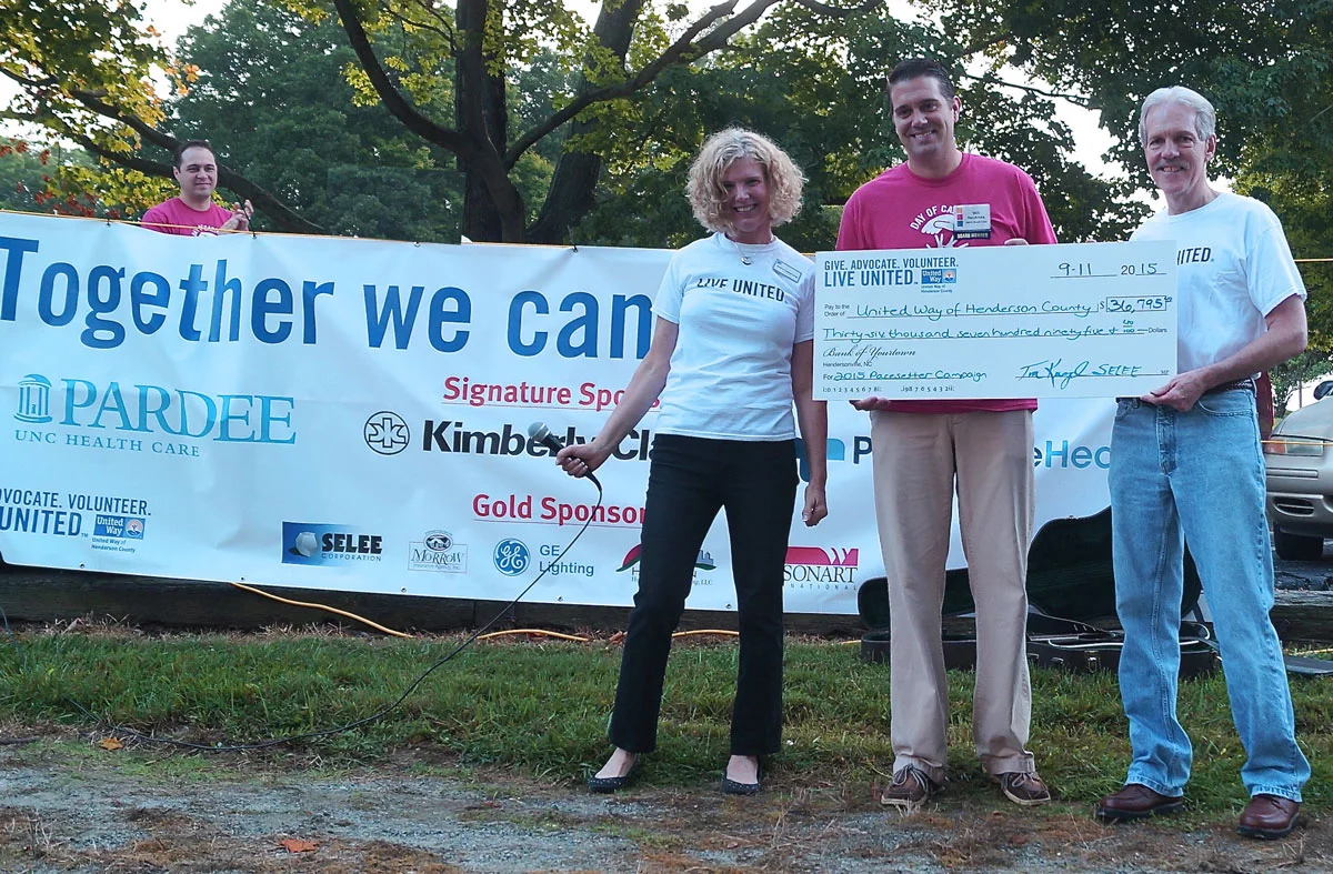 Tim Kriegel (R), CFO of SELEE Corporation, presents a check for $36,795 to the United Way of Henderson County.