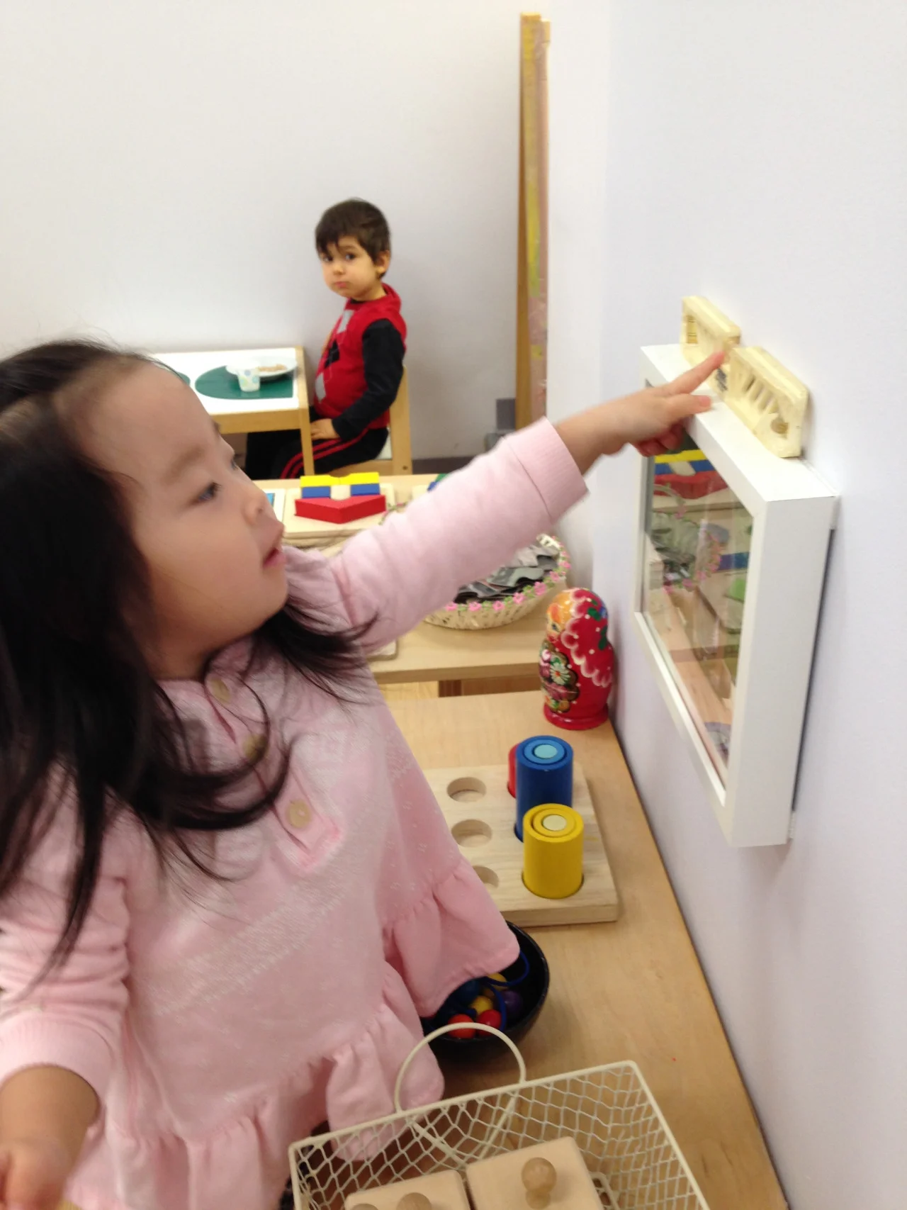 Recently, a level was discovered on the shelf in
the Toddler 1 classroom. Many students
enjoy sitting peacefully watching the bubble go back and forth, while a few
were determined to learn how to use it. One
Toddler went around to each of the classroom photographs, step stool in tow,
carefully examining the tiny bubble to test how level the artwork was hanging!