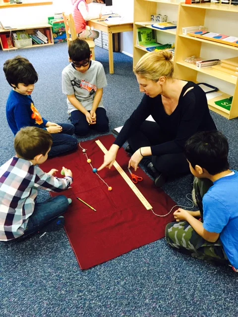 A Lower Elementary West student brought his own planet
models from home. He and his classmates used
them to measure out a representation of the distance between planets. In this case, one inch equaled six million
miles. The students were excited to see
that this scale just fit the length of their classroom!
