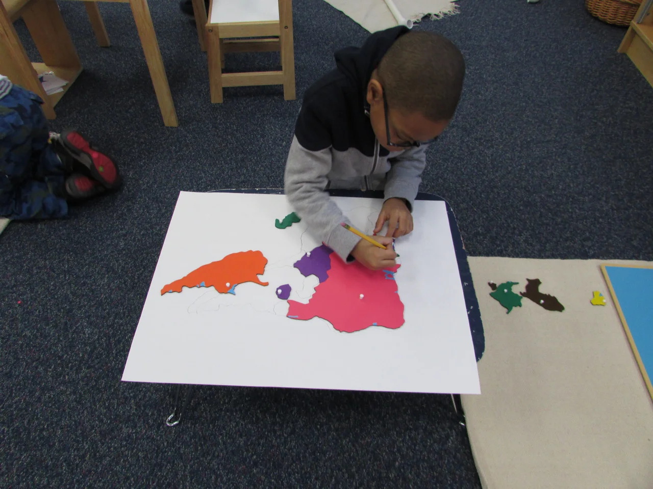 Map making is a popular work in the Primary 3
classroom. The older students are
encouraged to rebuild the map puzzle onto white paper and then trace each
country before coloring it in. This
requires lots of concentration and helps to develop fine motor skills.