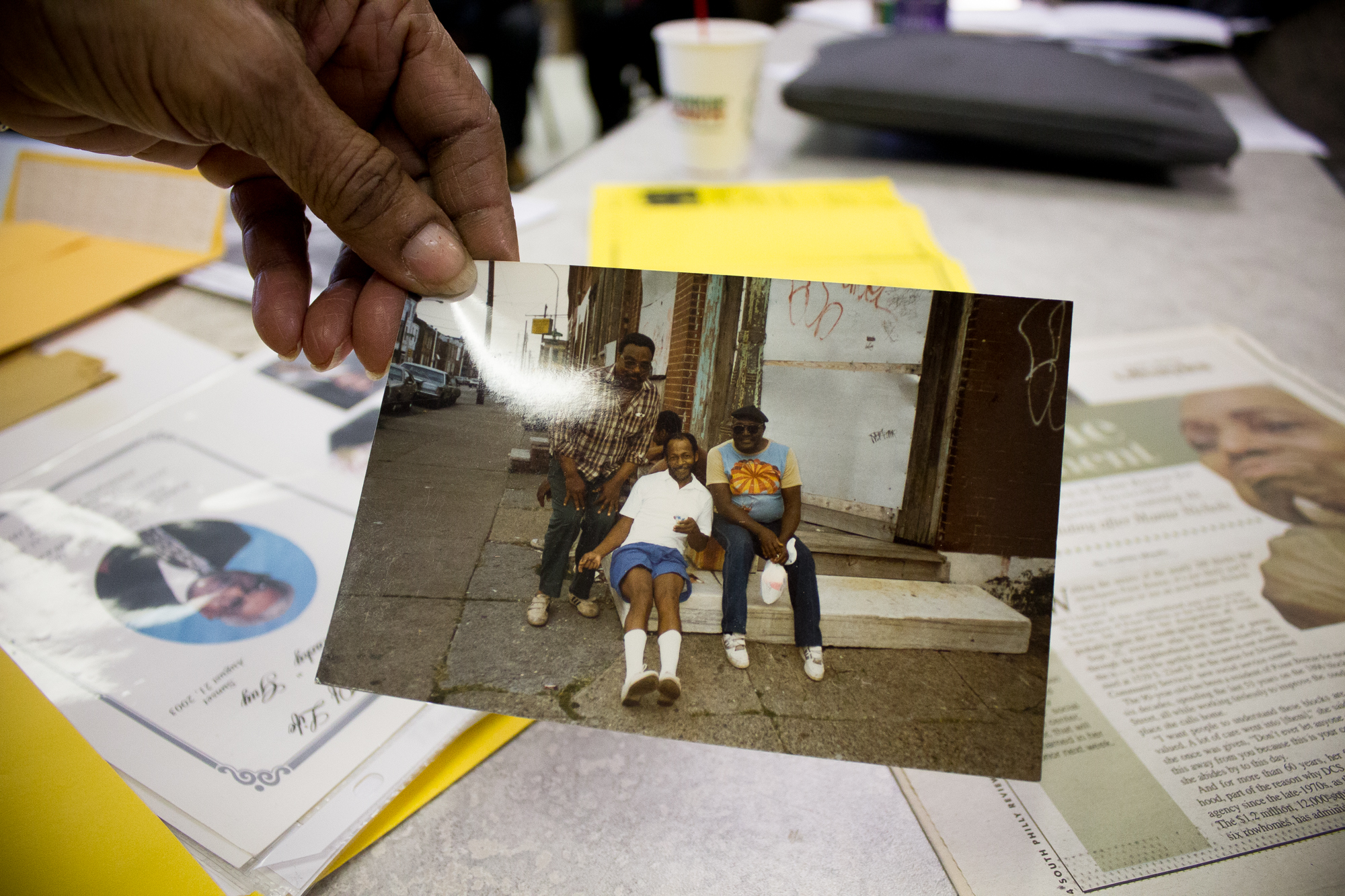  Alice Gabbadon, 74, holds a picture of her late brother,&nbsp;Charlie (center), and two of his friends sitting on the corner of 22nd and Greenwich in Point Breeze, Philadelphia.  "He's dead, he's dead, he's dead," Gabbadon said, pointing to each of 