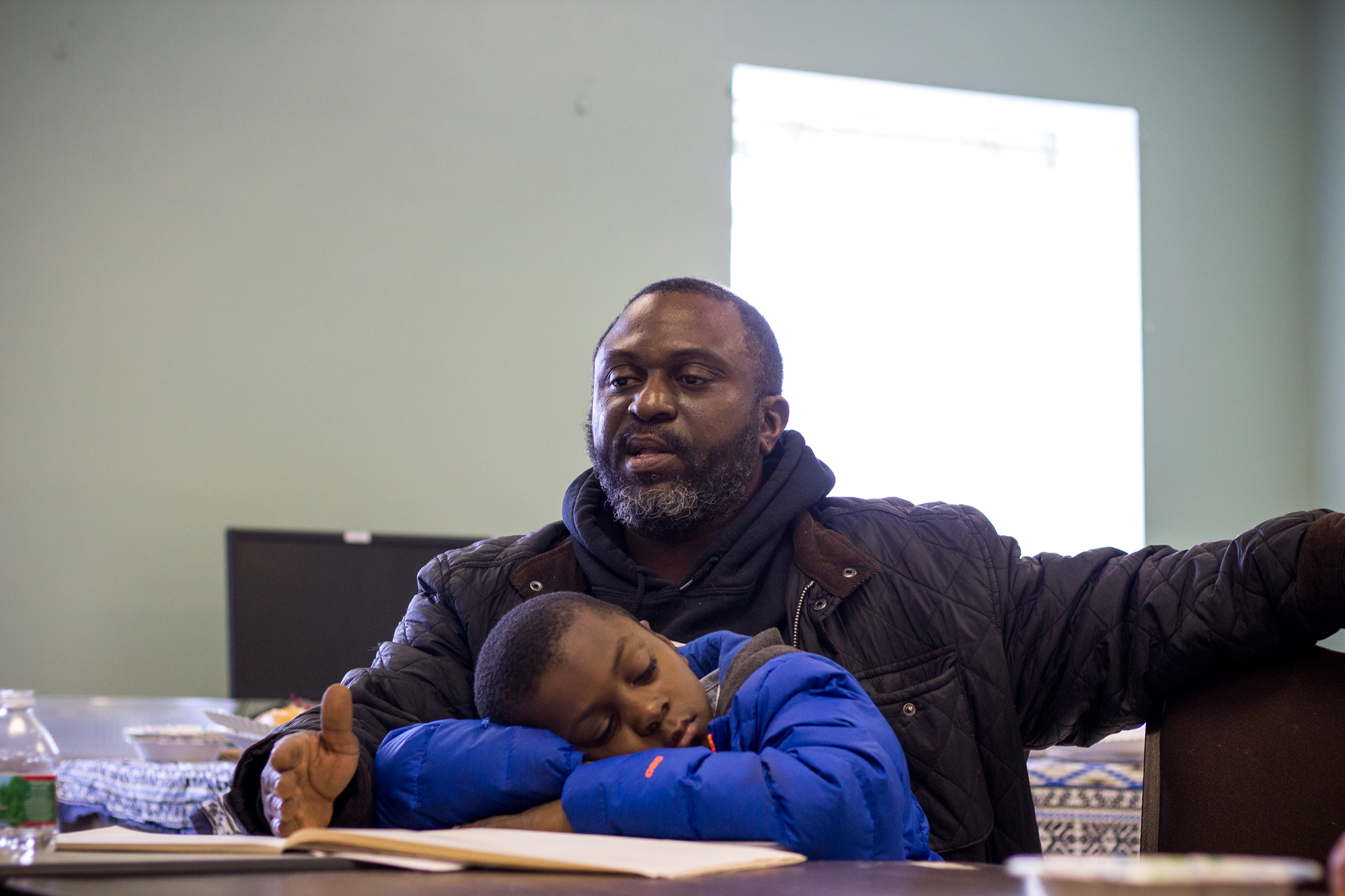  Al Custis, 42, speaks during The Redline Project workshop while his son,&nbsp;Kheli, 9, rests on his lap January 16, 2016.  "All I ever knew was 18th and Dickinson. It is somewhere, even now, I call a comfort zone for me. If I’m going through a situ