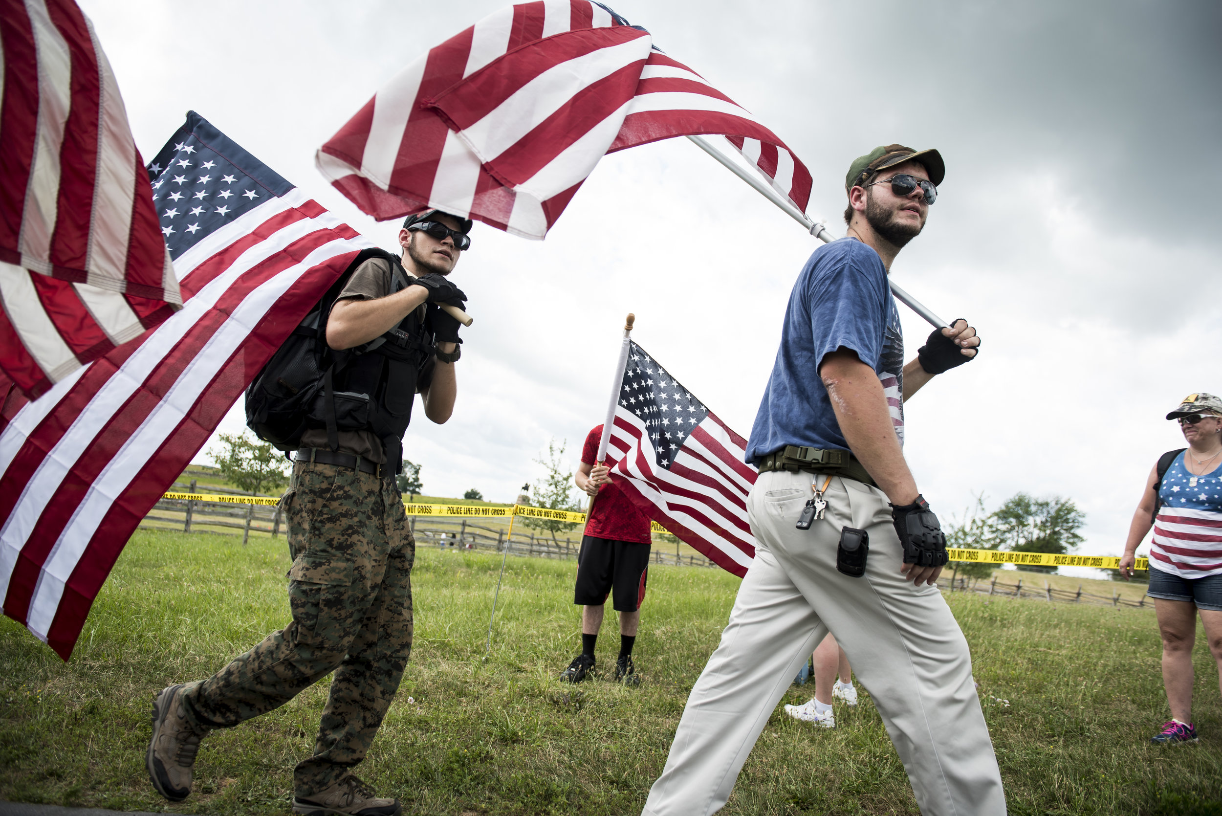  People carry American flags near a demonstration area at Gettysburg National Military Park.&nbsp; 