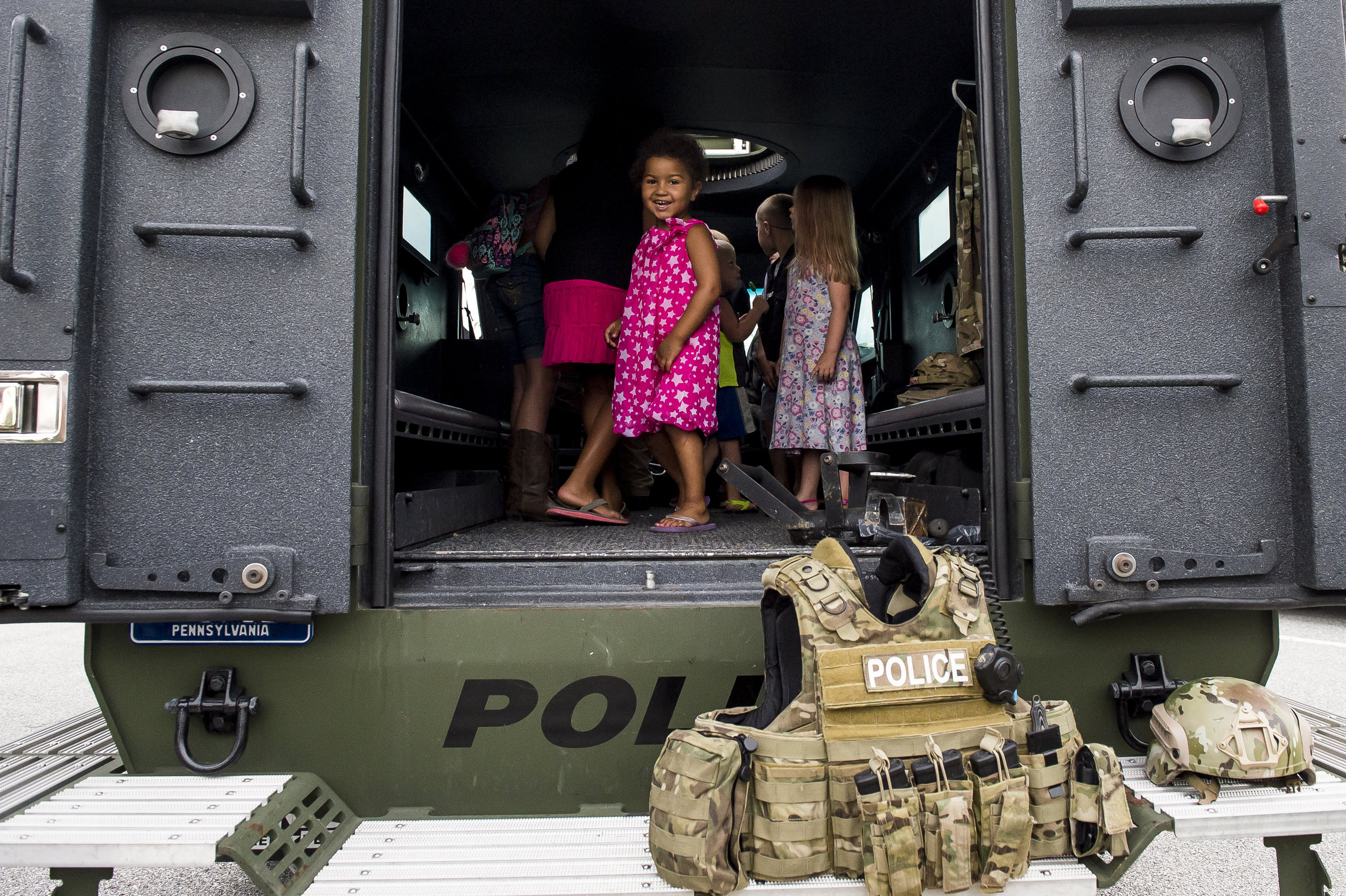  Starry Washington, 3, of McSherrystown, looks out from the inside of a police vehicle during a National Night Out event held in the parking lot of the Gateway Hanover shopping center in Penn Township.  