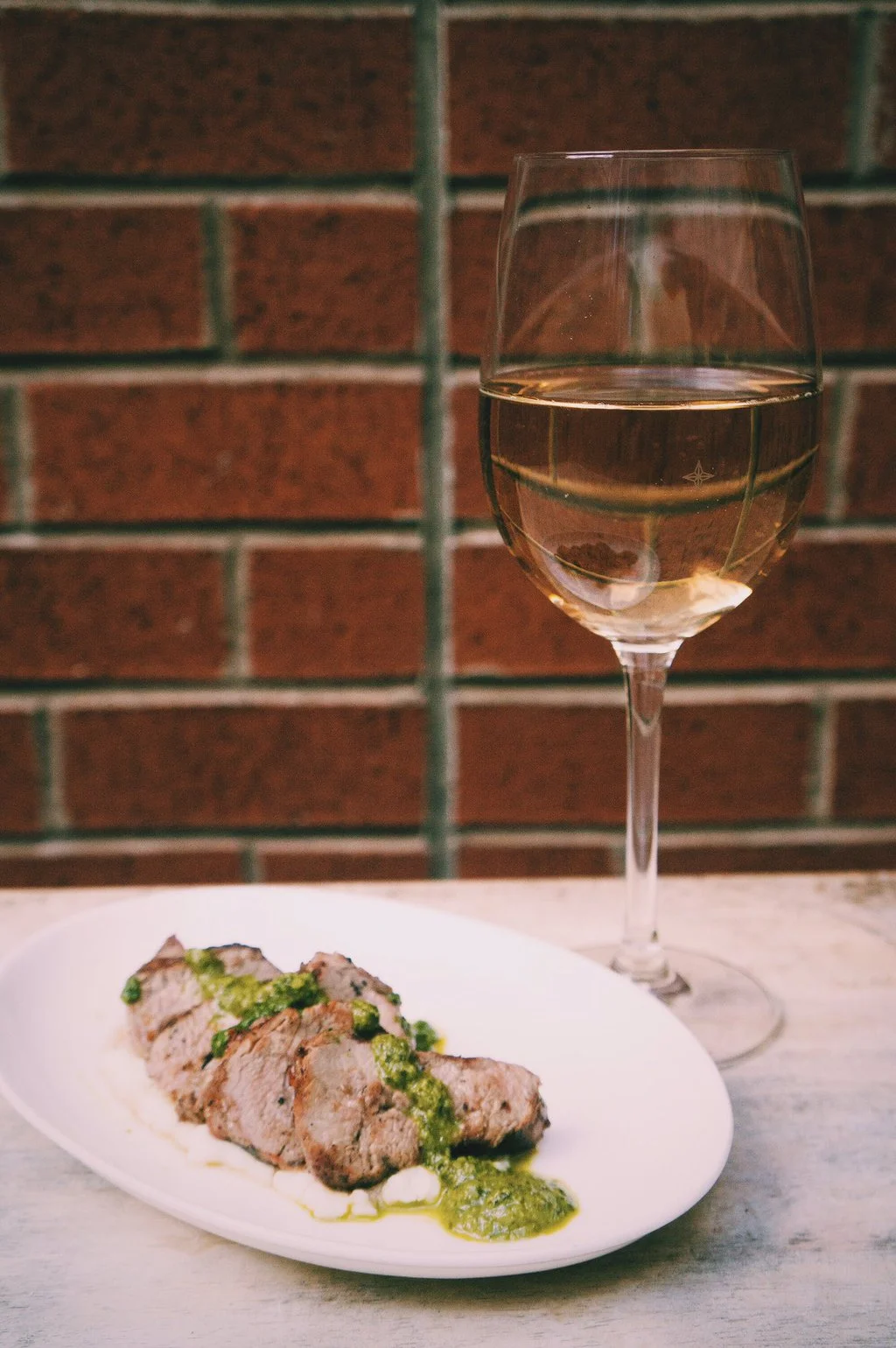 PORK TENDERLOIN spice-brined pork, goat cheese polenta, orange, rosemary gremolata