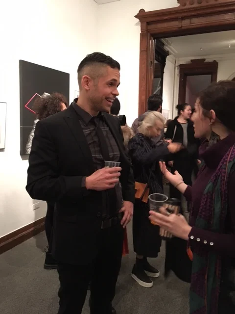 Jon Levy, Gallery House Program Coordinator greets patrons